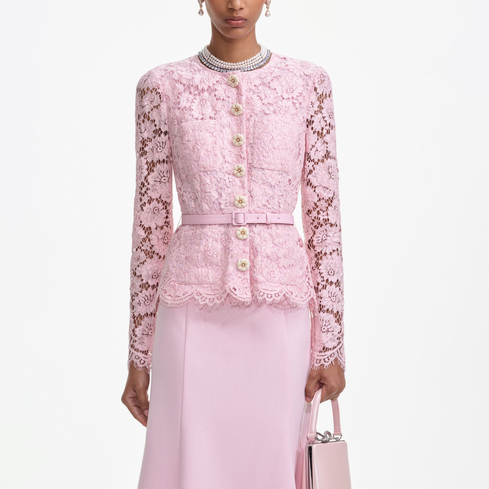 A close up of a woman wearing the Pink Tailored Lace Midi Dress