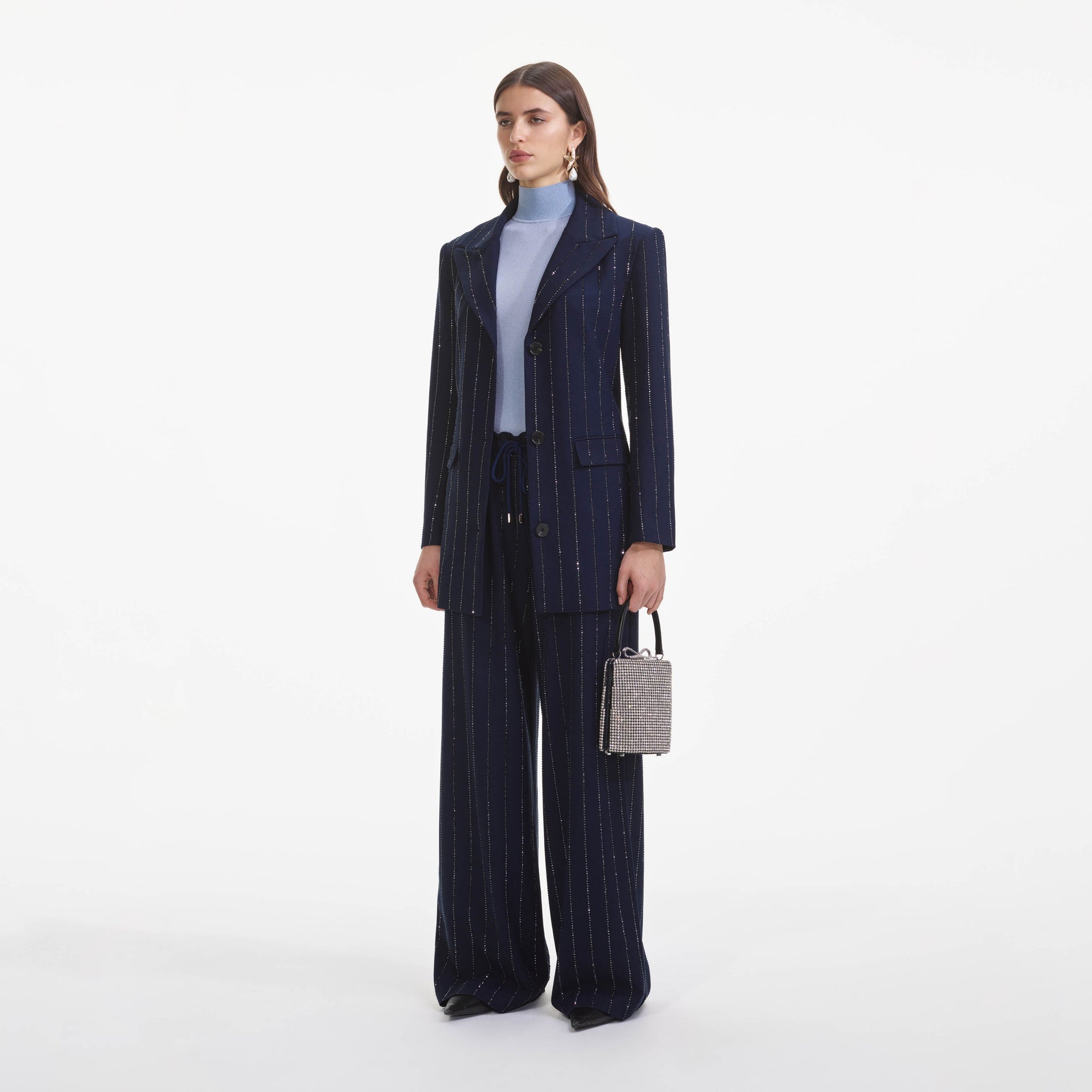 Side view of a woman wearing the Navy Rhinestone Pinstripe Trousers