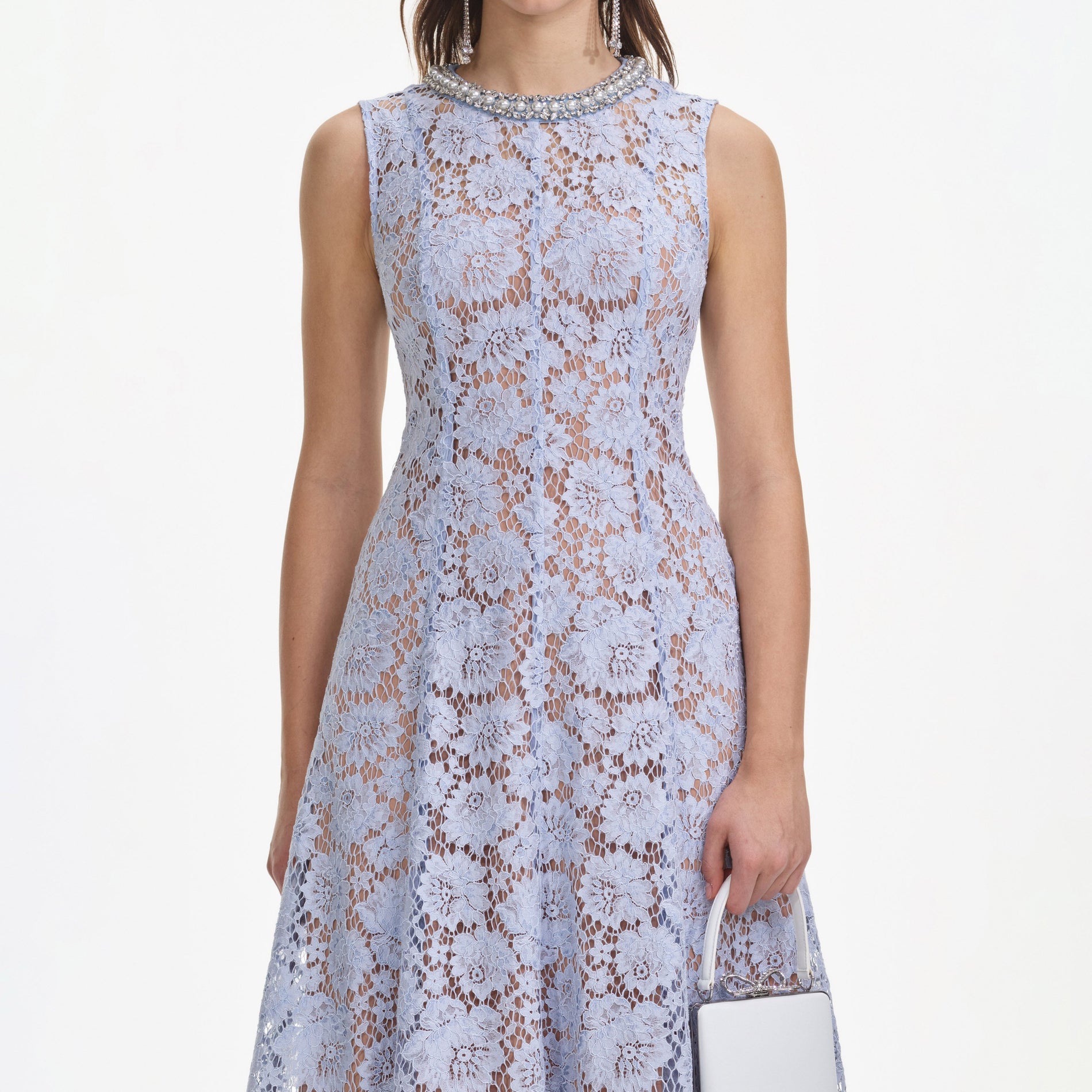 A close up of a woman wearing the Blue Fine Lace Pearl Midi Dress