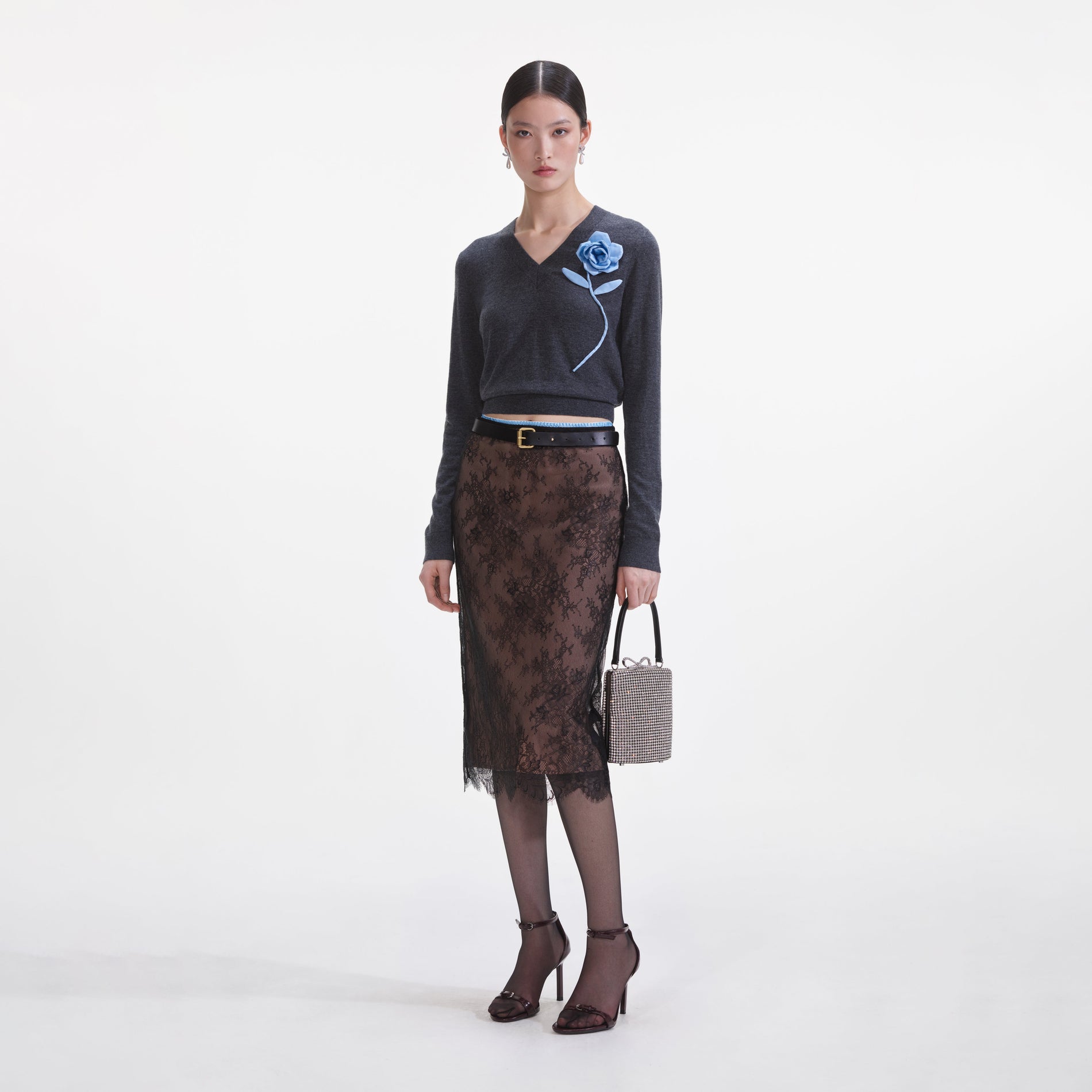 Side view of a woman wearing the Black Lace Midi Skirt