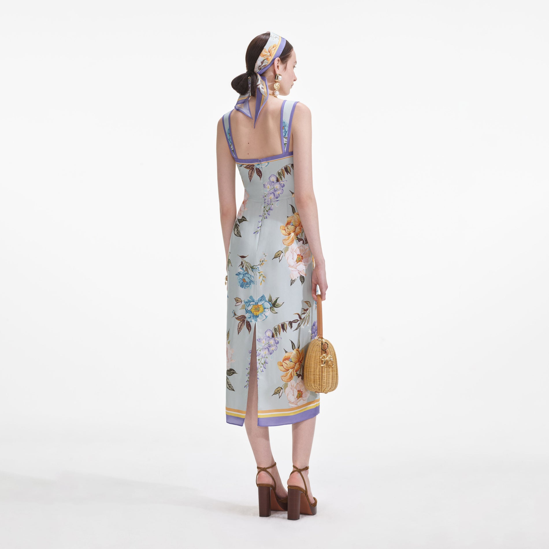 Back view of a woman wearing the Blue Floral Silk Twill Midi Dress