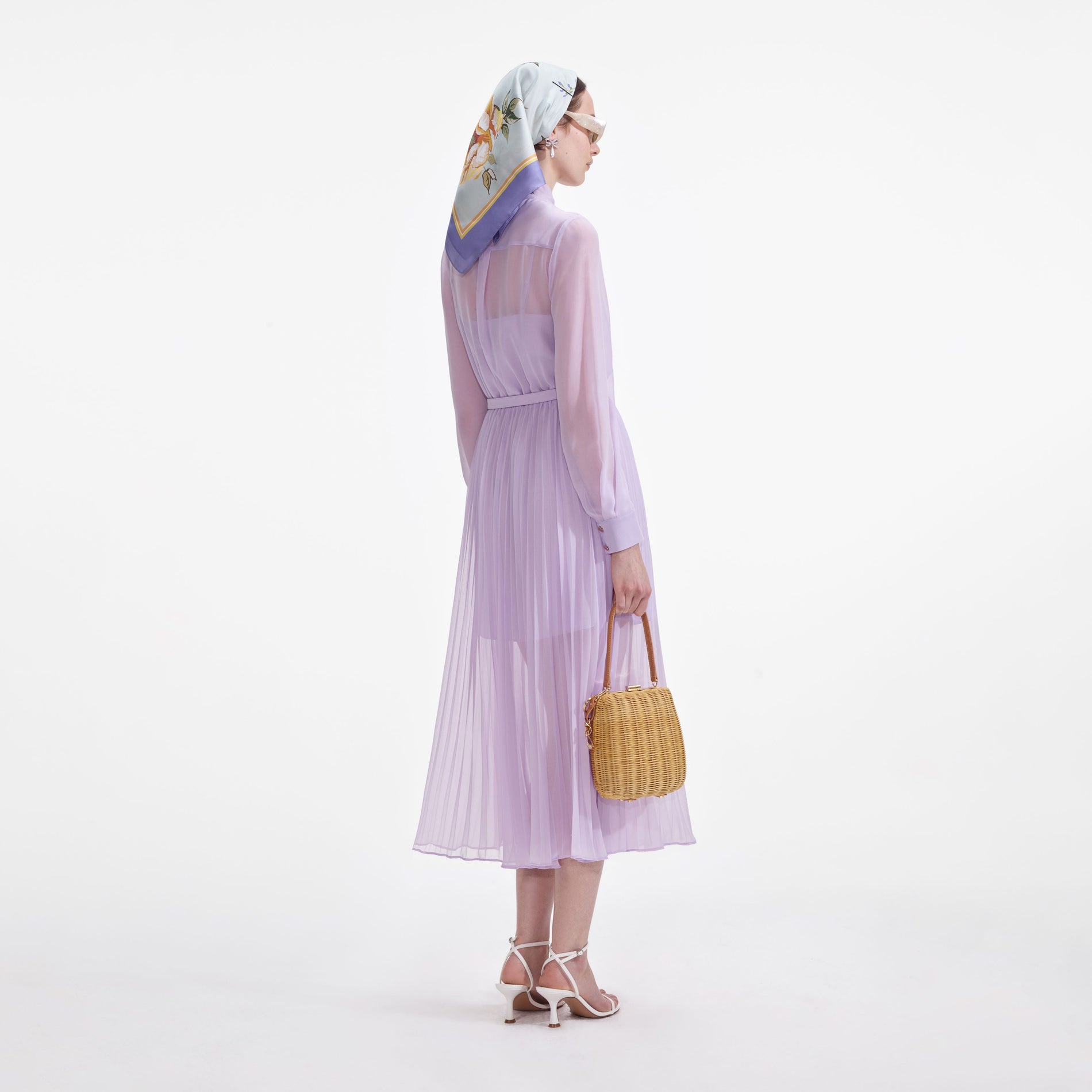 Back view of a woman wearing the Lilac Chiffon Pussy Bow Midi Dress