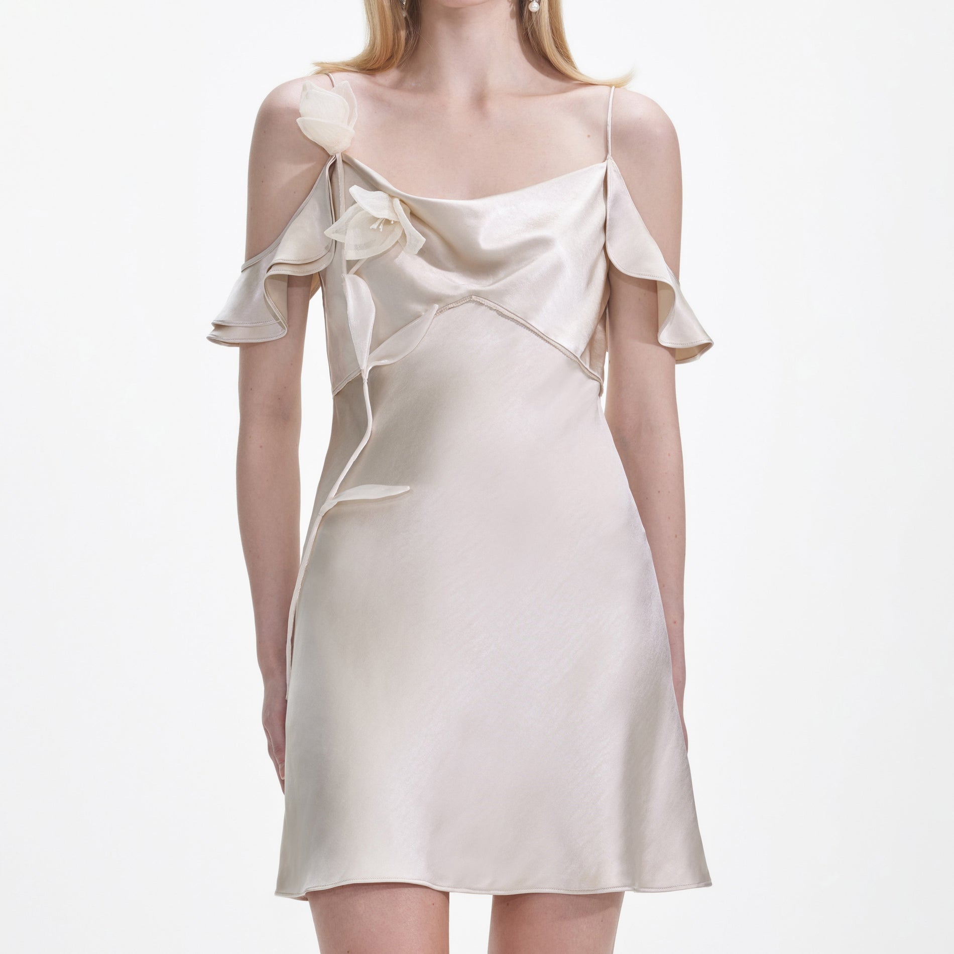 A close up of a woman wearing the Champagne Flower Satin Mini Dress