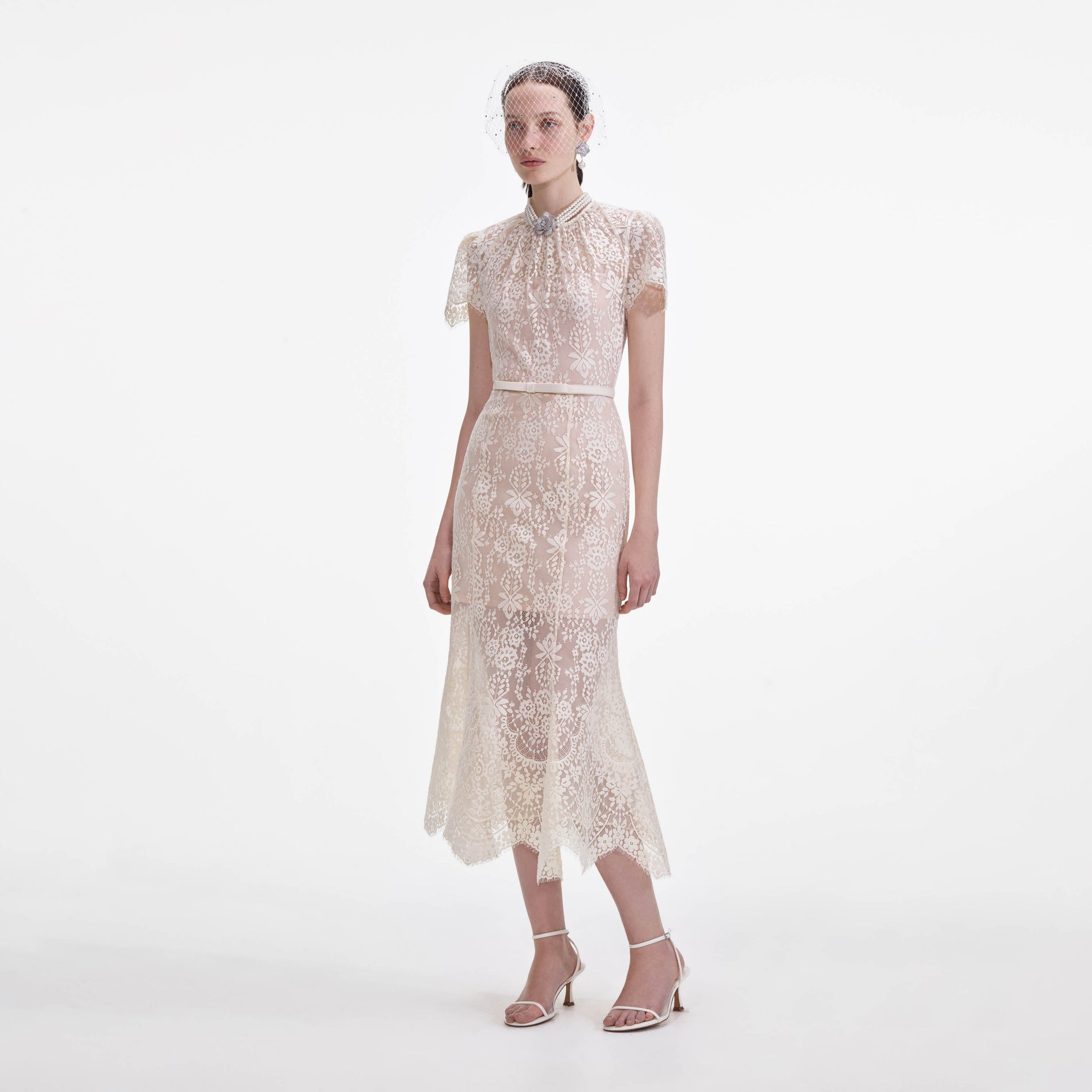 Side view of a woman wearing the White Lace Midi Dress