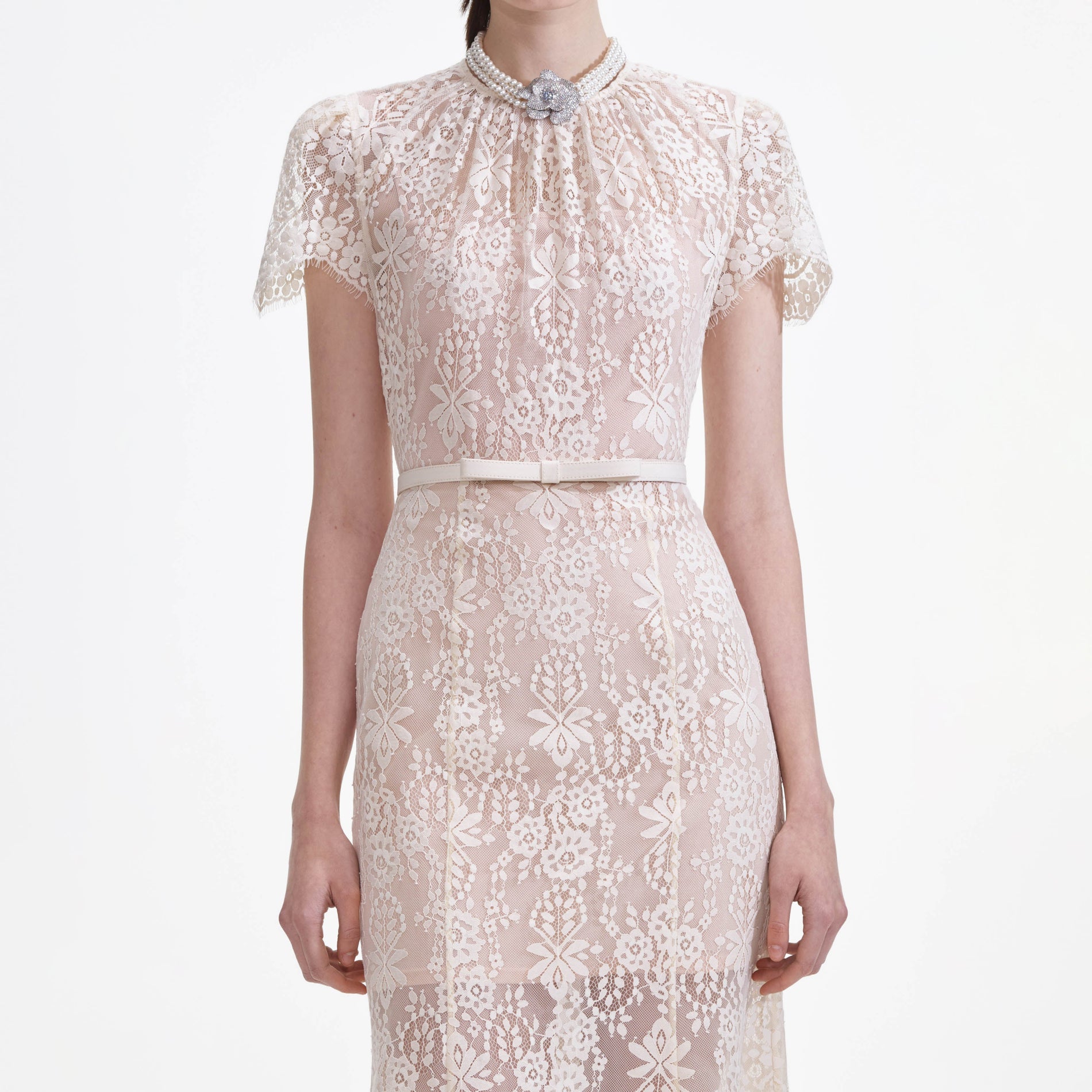 A close up of a woman wearing the White Lace Midi Dress