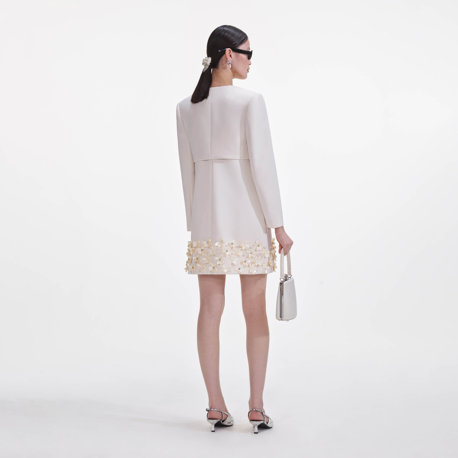 Back view of a woman wearing the Cream Crepe 3D Sequin Jacket