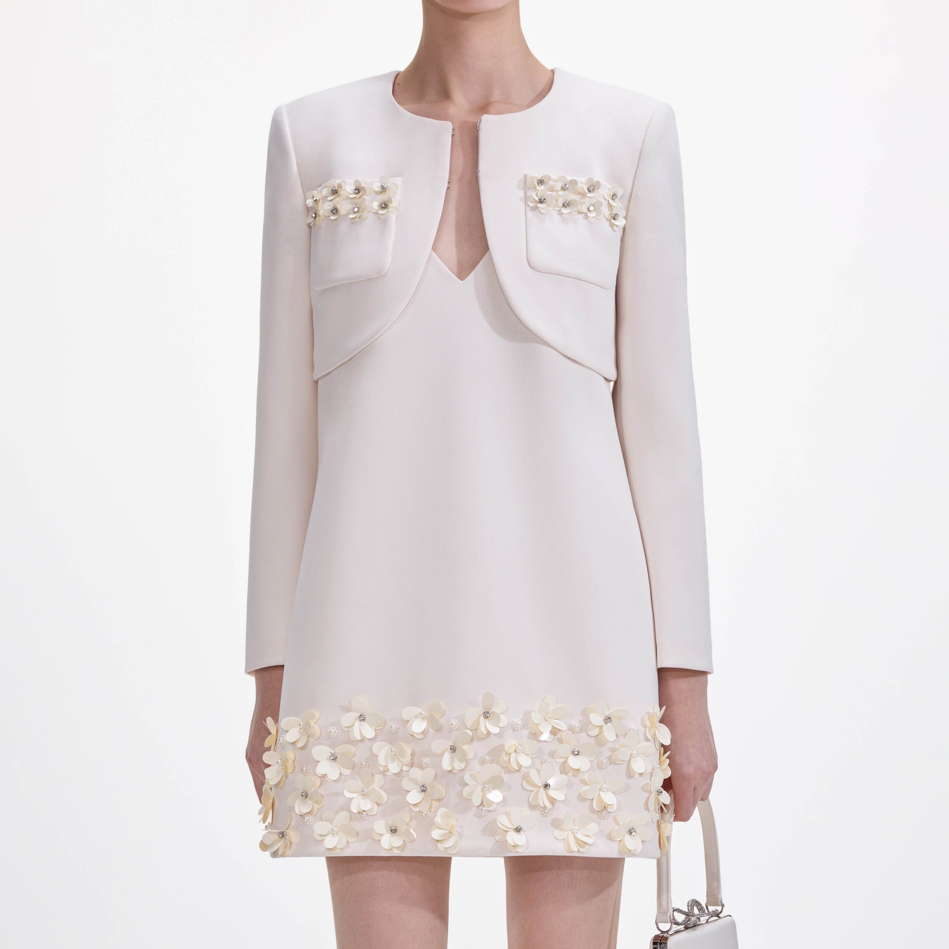 A close up of a woman wearing the Cream Crepe 3D Sequin Jacket