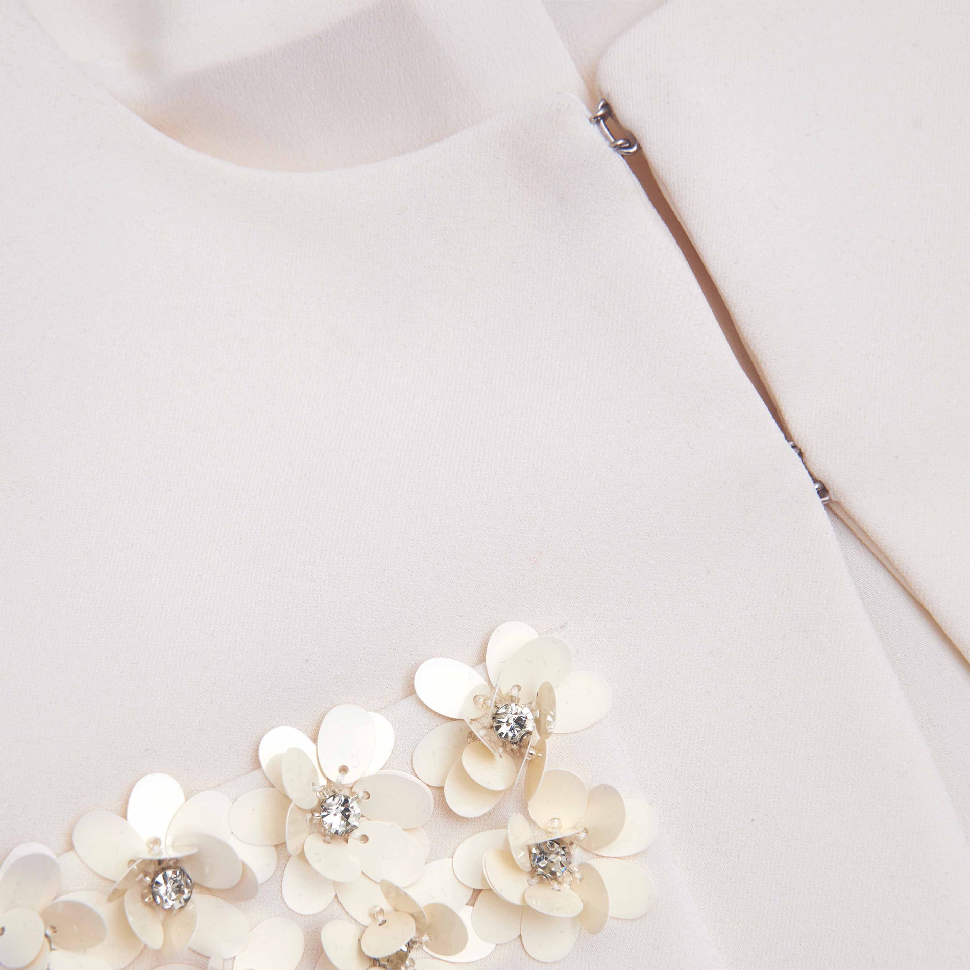 Side view of a woman wearing the Cream Crepe 3D Sequin Jacket