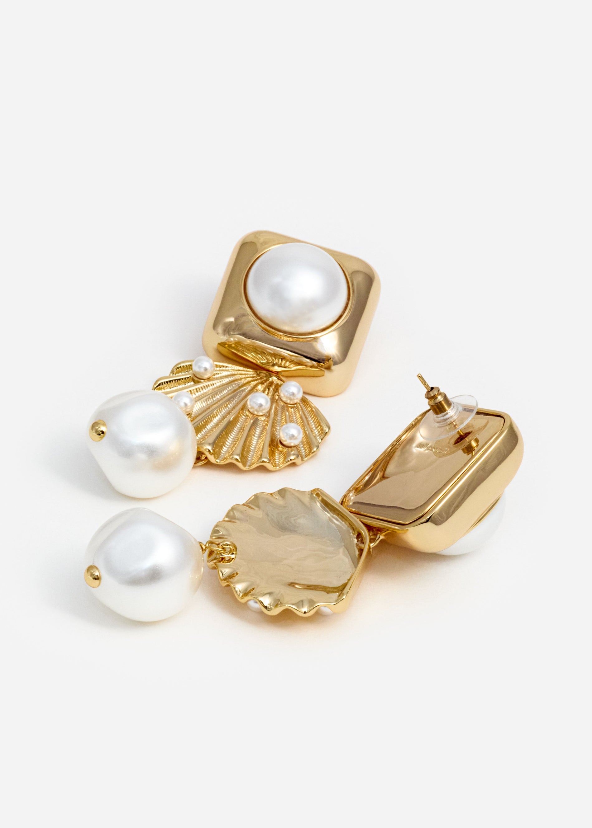 A photo of the Gold Pearl Shell Earrings