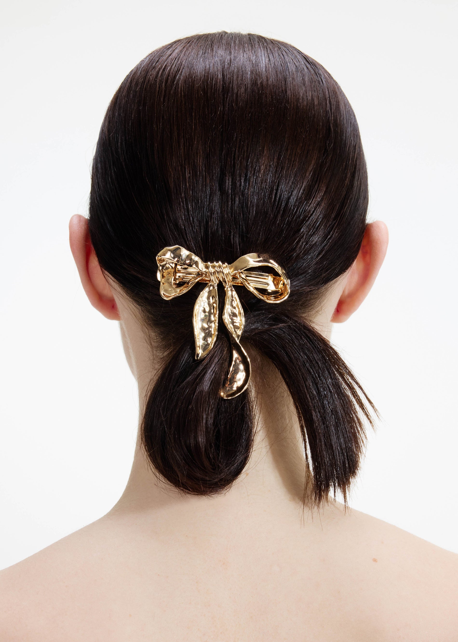 A photo of the Mottled Gold Bow Hairclip