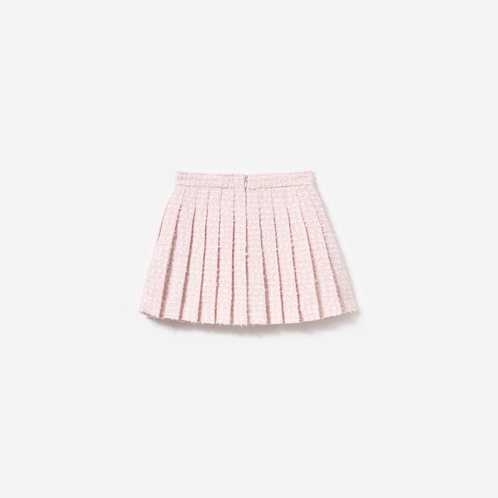 Side view of a woman wearing the Pink Bow Boucle Skirt