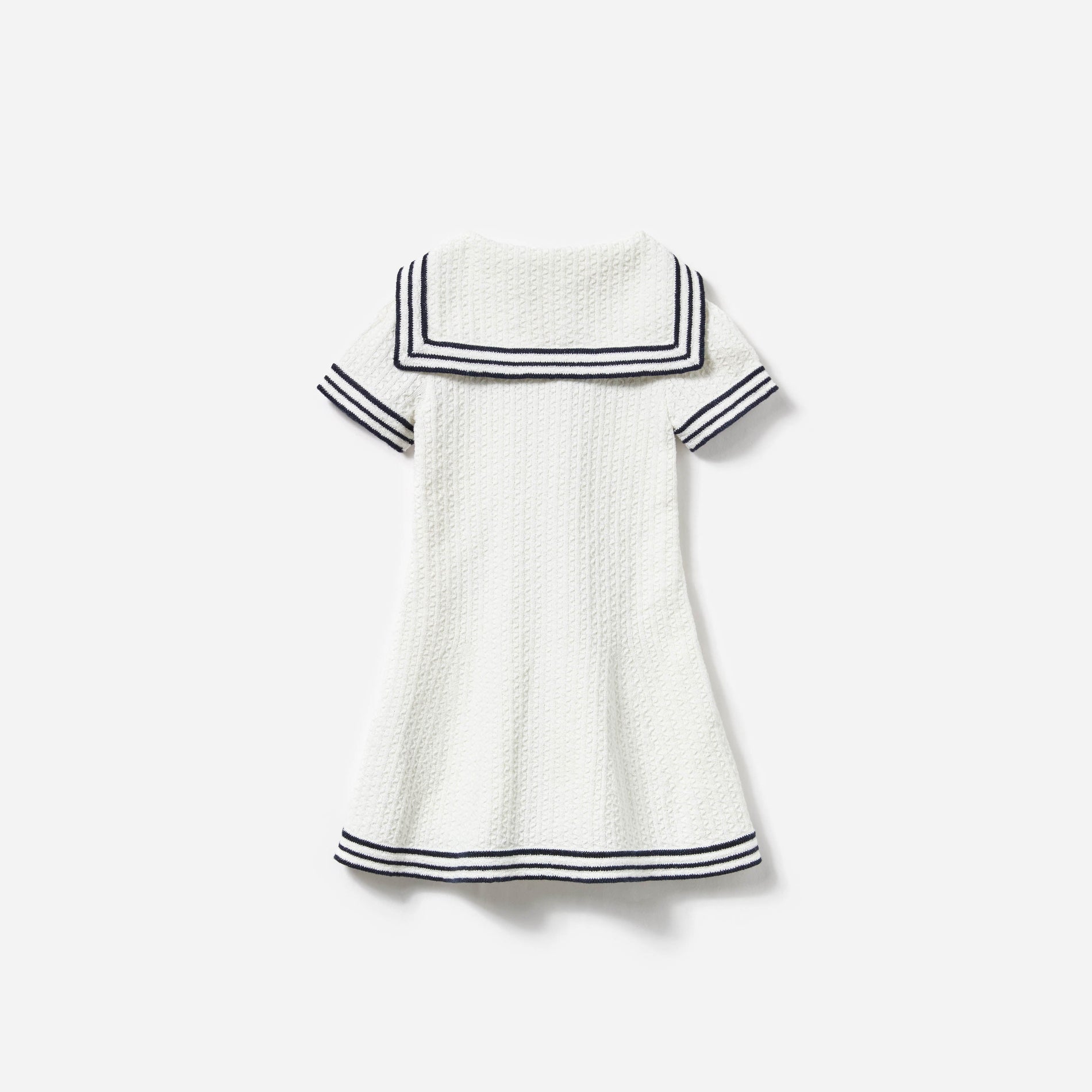 Side view of a woman wearing the Cream Textured Knit Dress