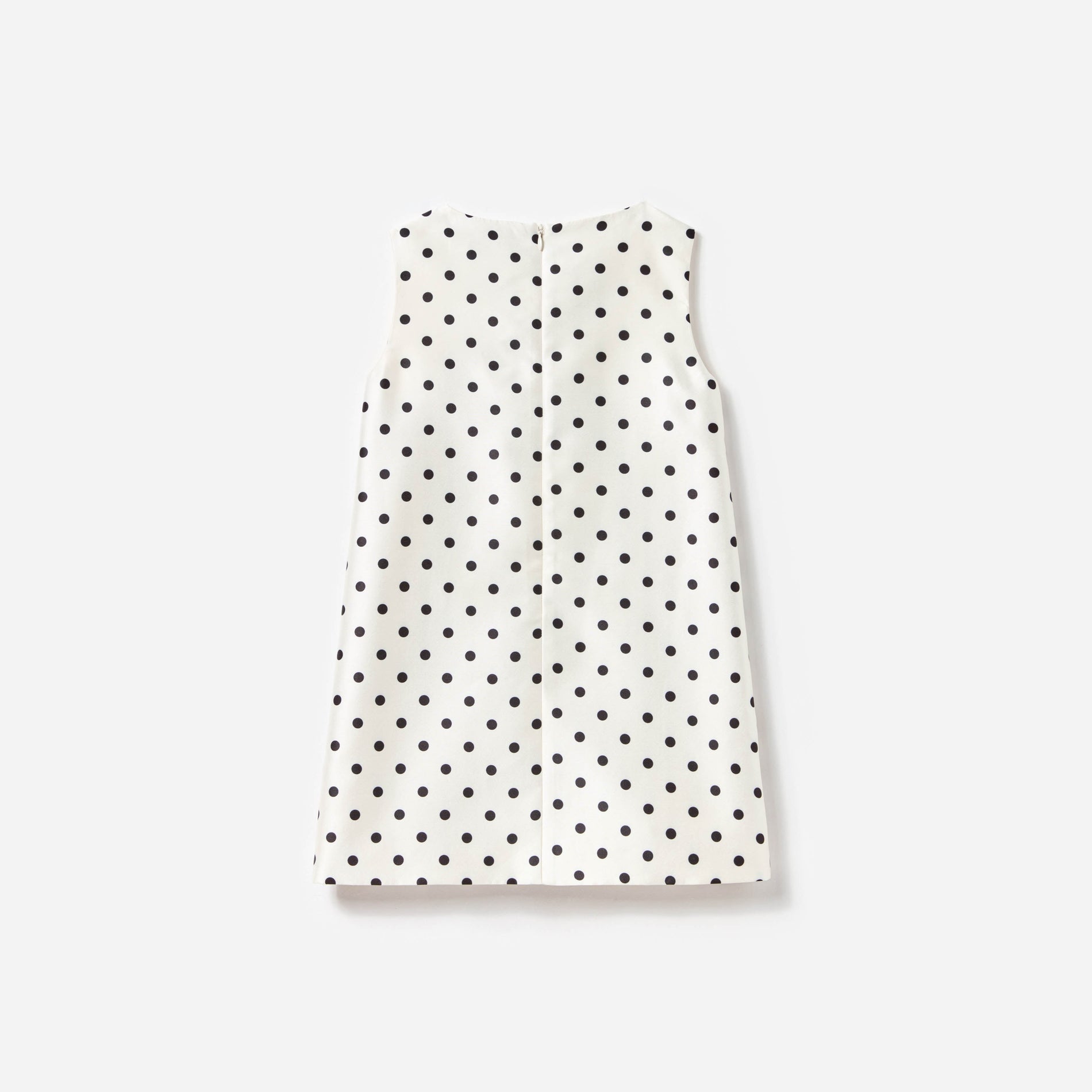 Side view of a woman wearing the Cream Sleeveless Polka Dot Taffeta Dress