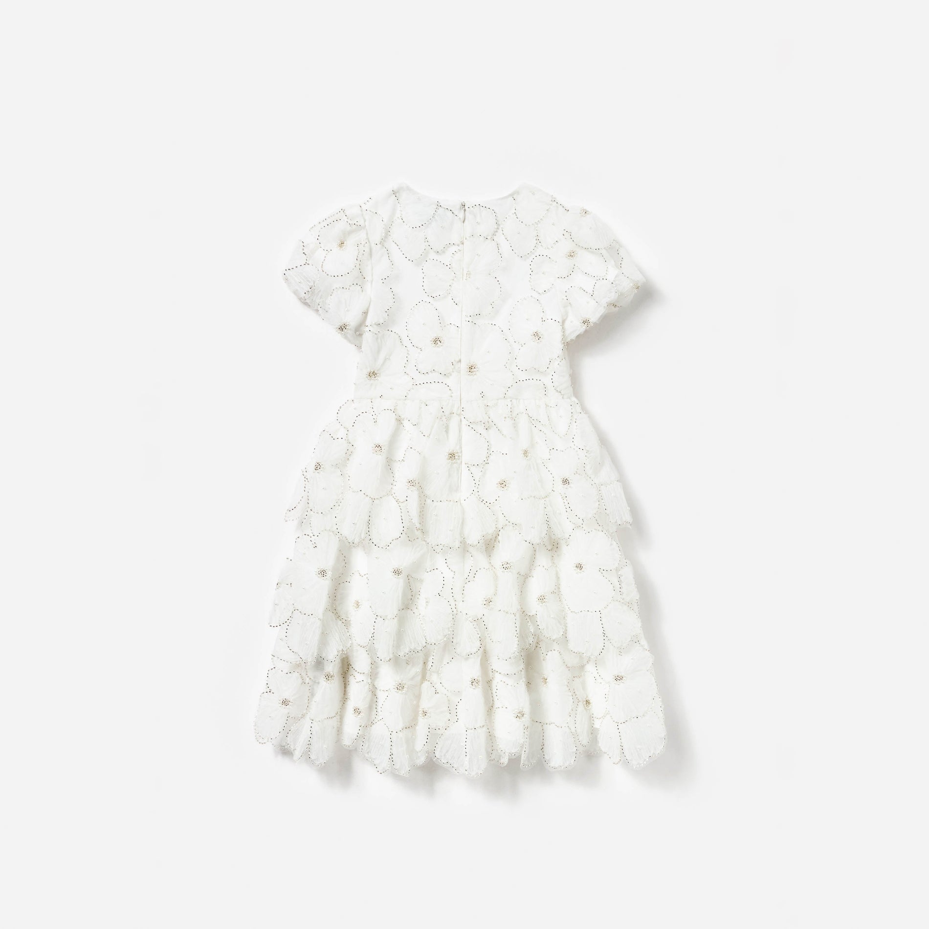 Side view of a woman wearing the White Embellished Tulle Short Sleeve Dress