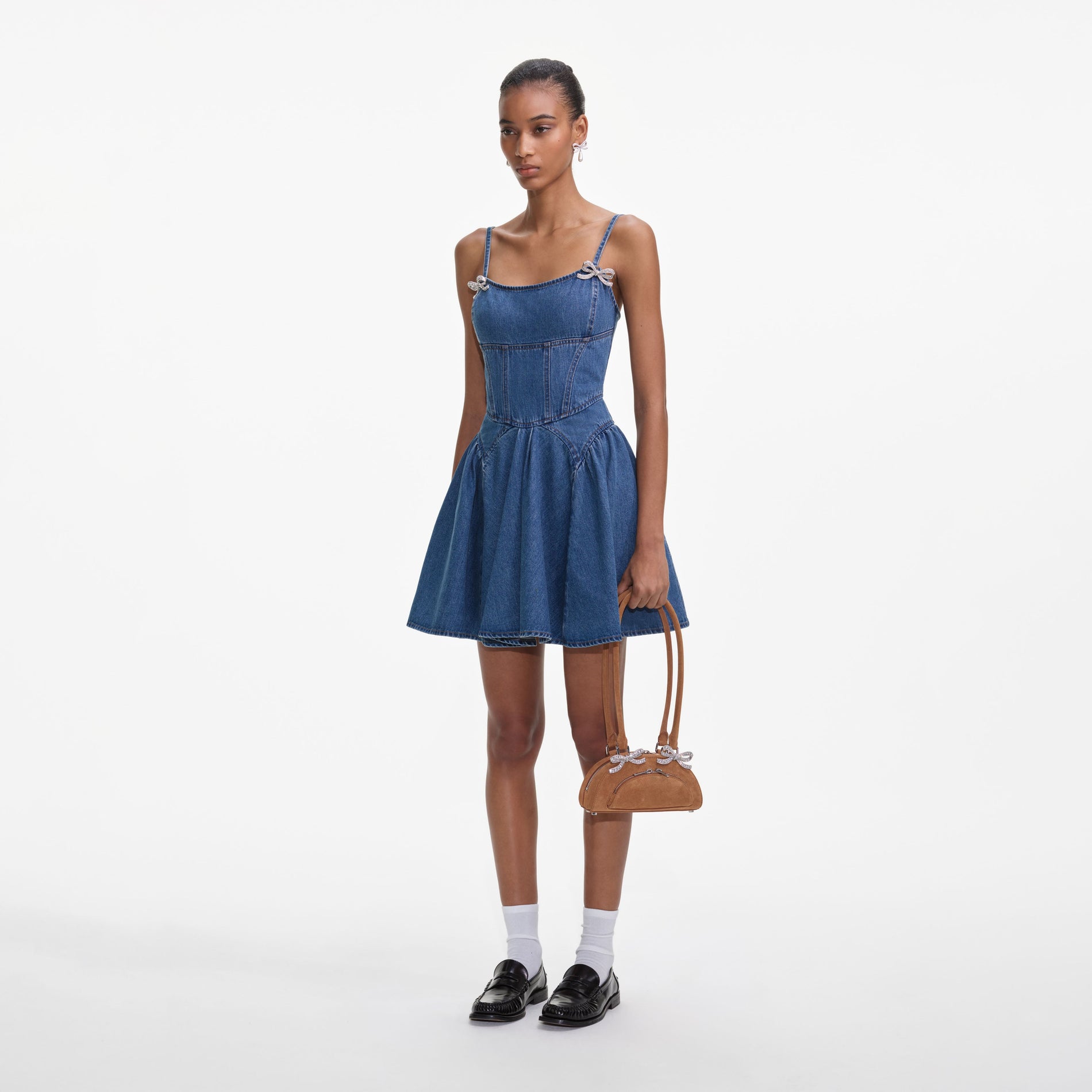 Side view of a woman wearing the Lightweight Denim Flared Mini Dress