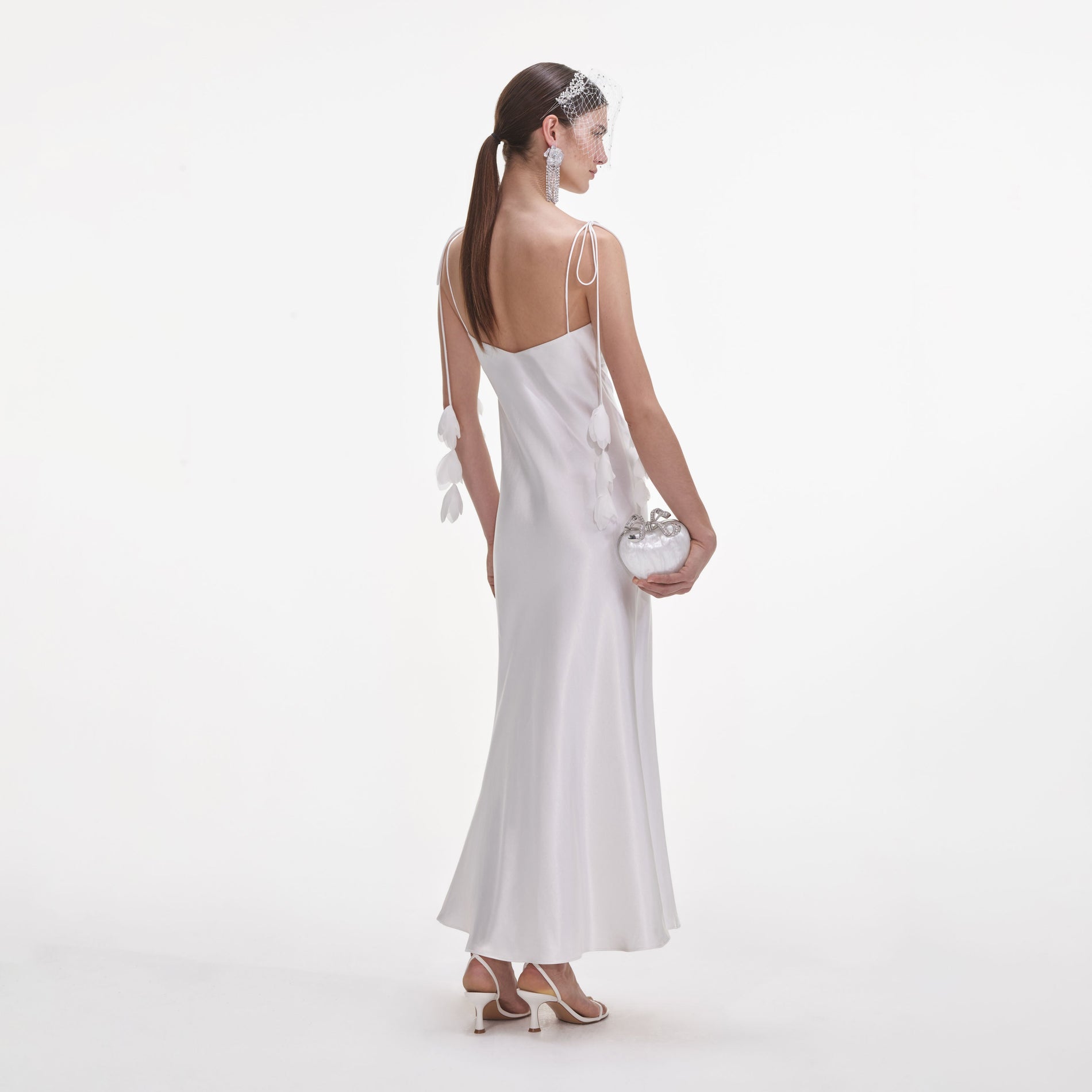 Back view of a woman wearing the White Satin Flower Midi Dress