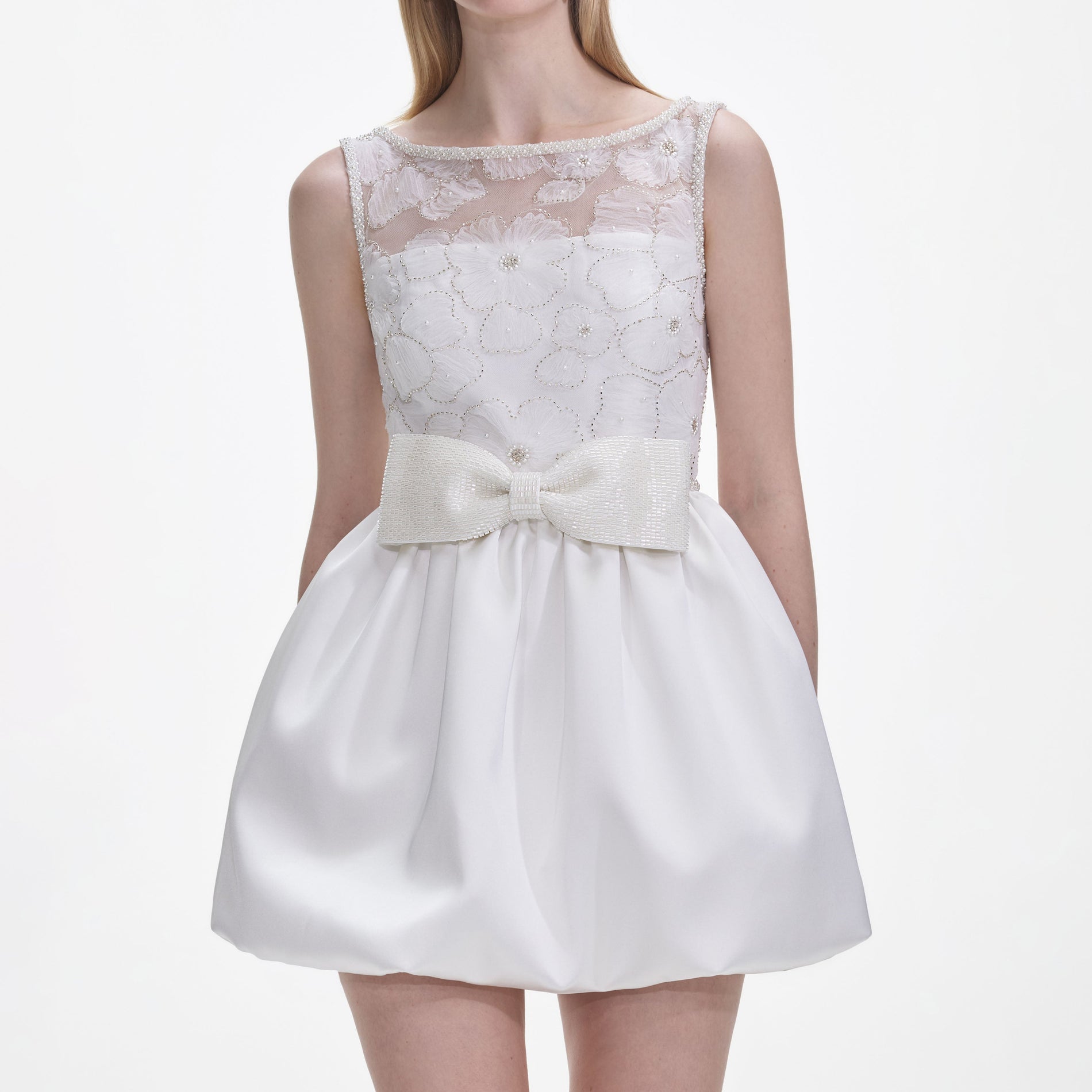 A close up of a woman wearing the White Tulle Mini Dress