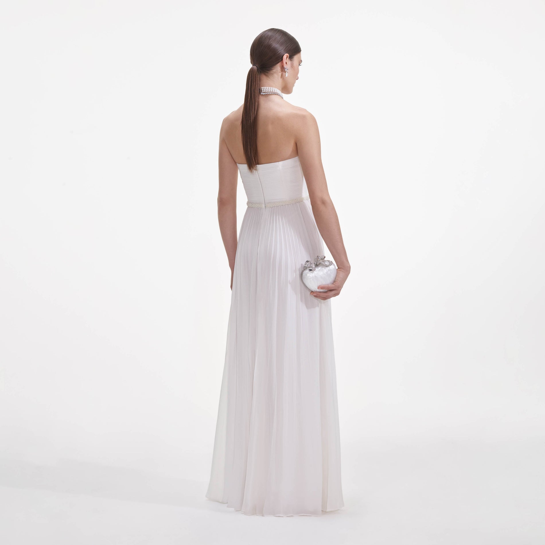 Back view of a woman wearing the White Chiffon Bow Maxi Dress