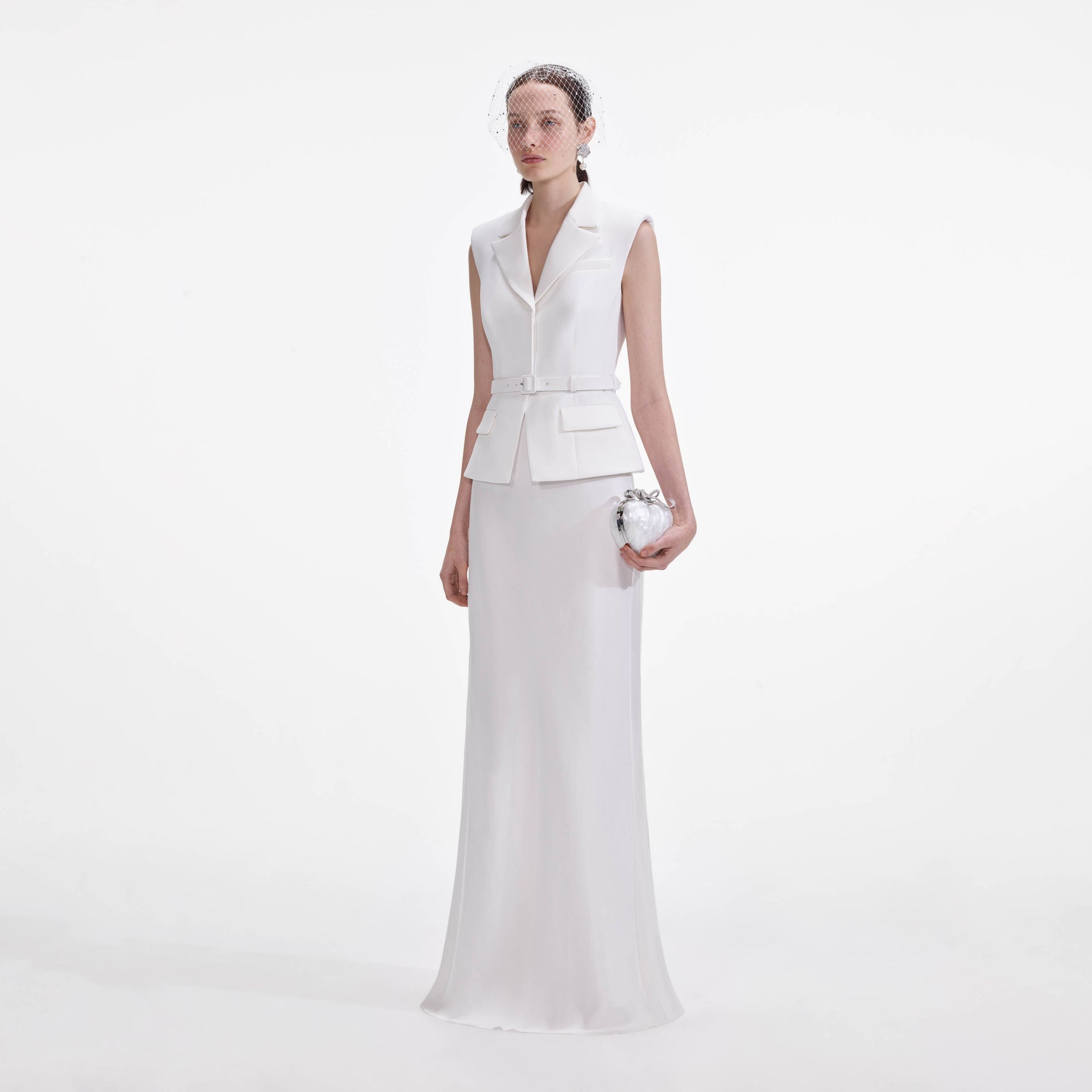 Side view of a woman wearing the White Crepe Maxi Dress