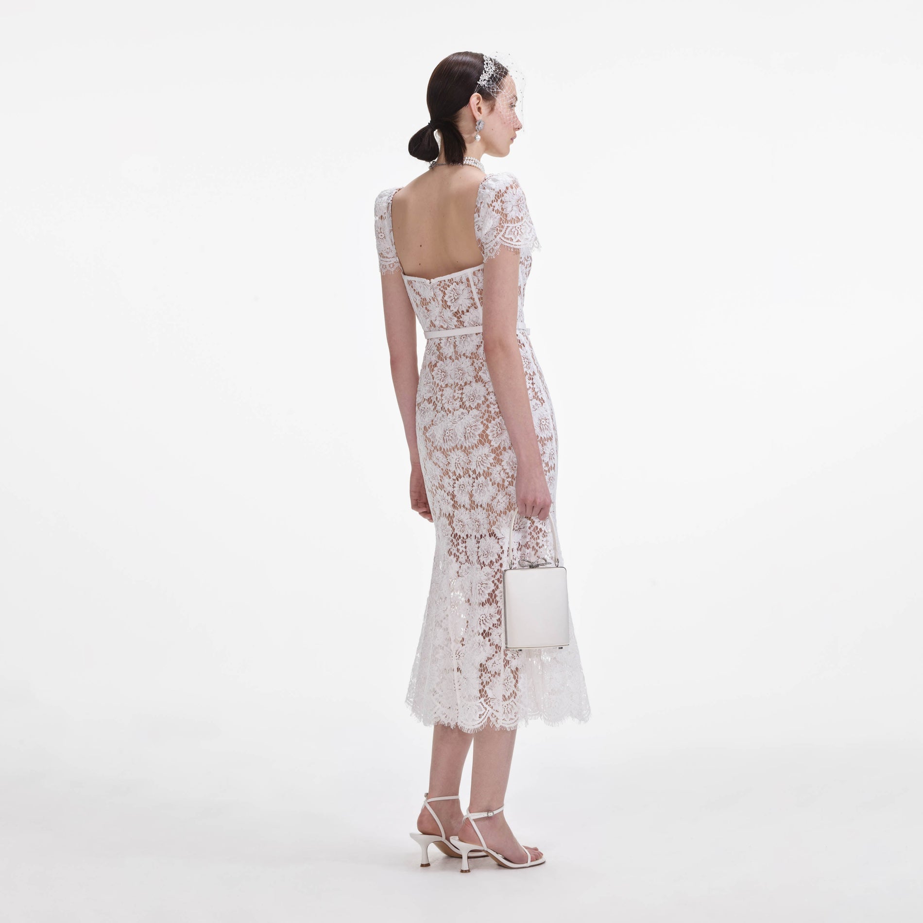 Back view of a woman wearing the White Fine Lace Midi Dress