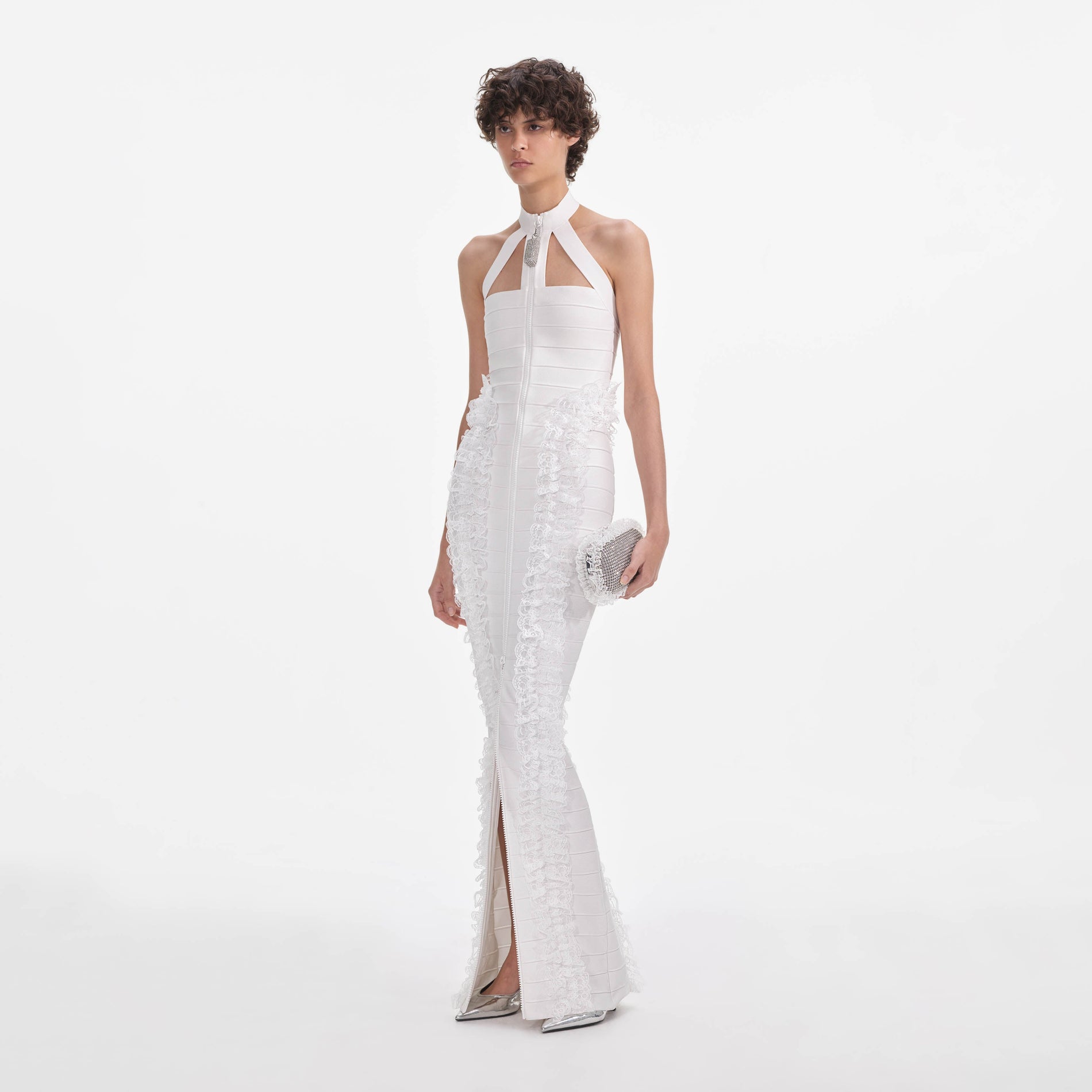 Side view of a woman wearing the White Knit Zip Ruffle Maxi Dress