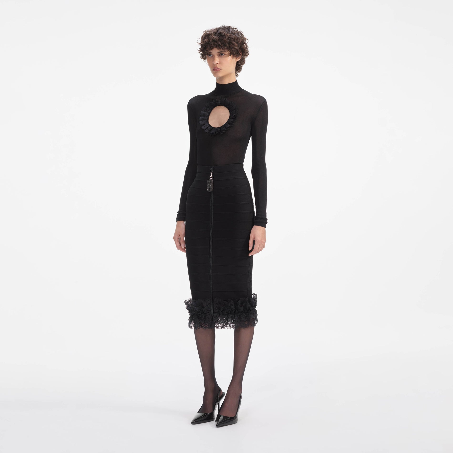 Side view of a woman wearing the Black Ruffle Knit Midi Skirt