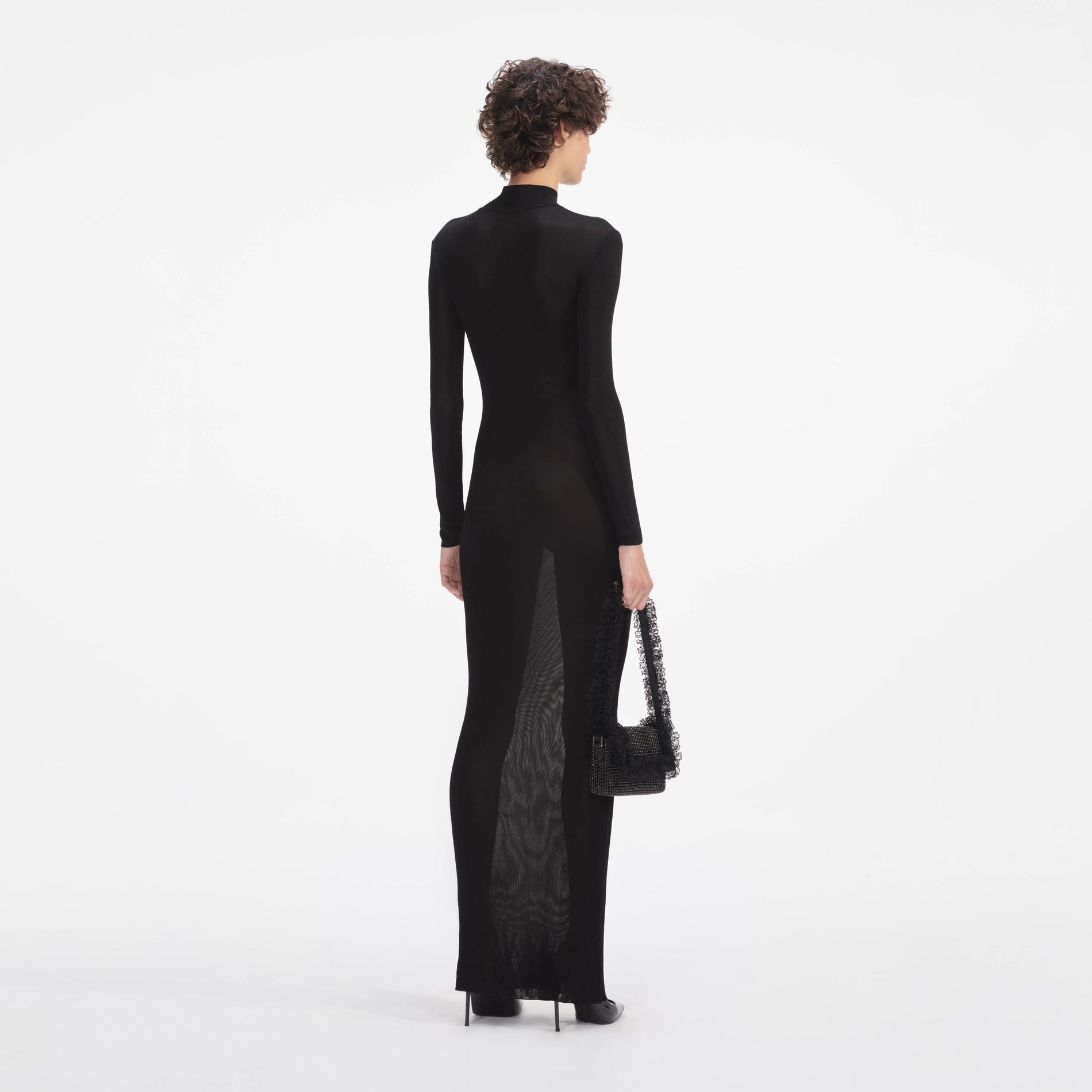 Back view of a woman wearing the Black Knit Cut Out Maxi Dress