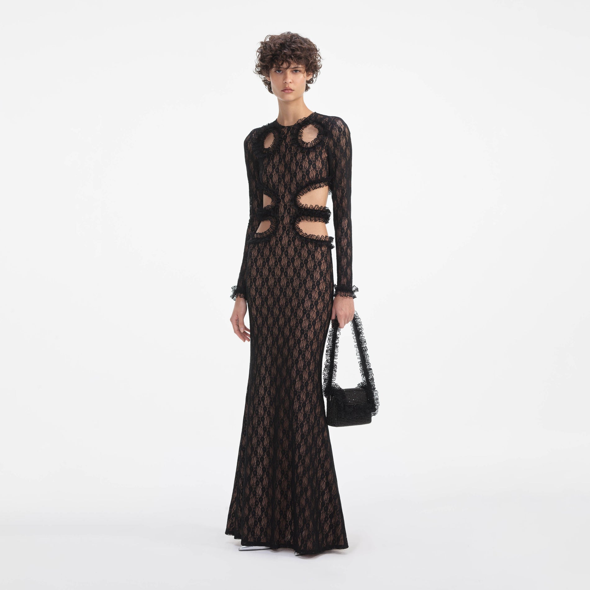 Side view of a woman wearing the Black Lace Cut Out Maxi Dress
