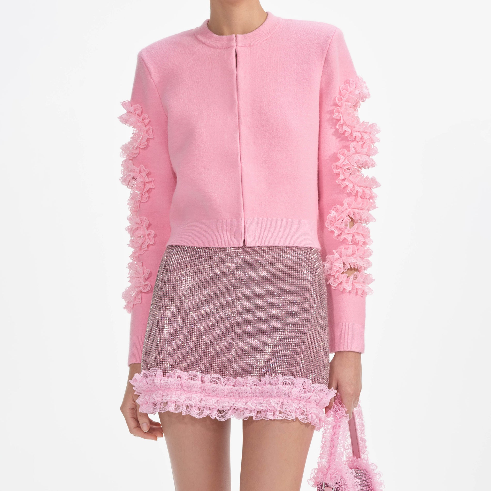 A close up of a woman wearing the Pink Crystal Chainmail Mini Skirt