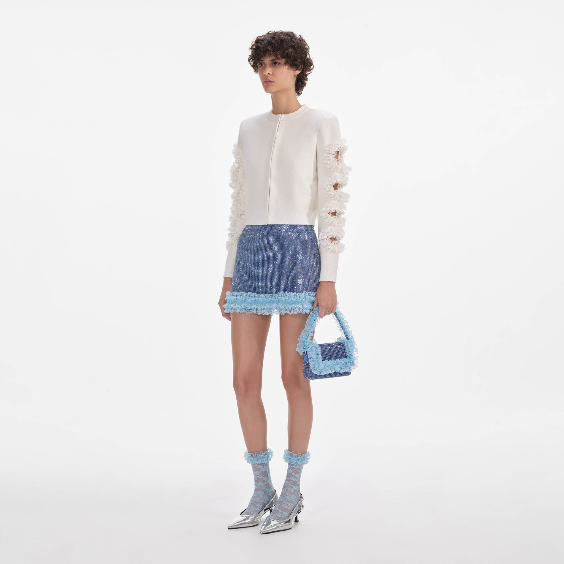 Side view of a woman wearing the Blue Crystal Chainmail Mini Skirt