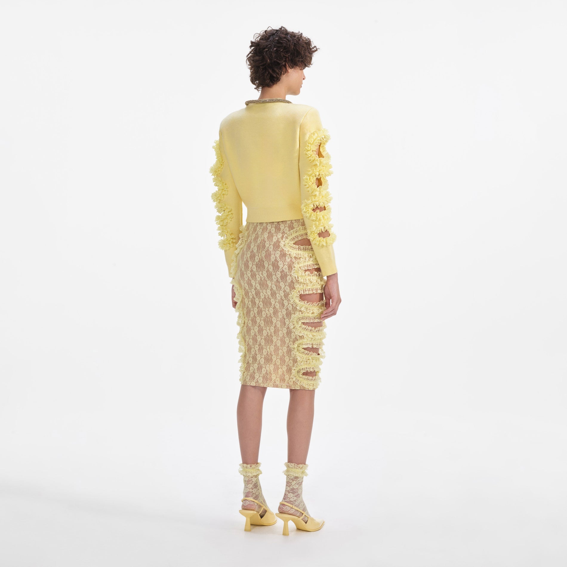 Back view of a woman wearing the Yellow Cut Out Lace Detail Jumper