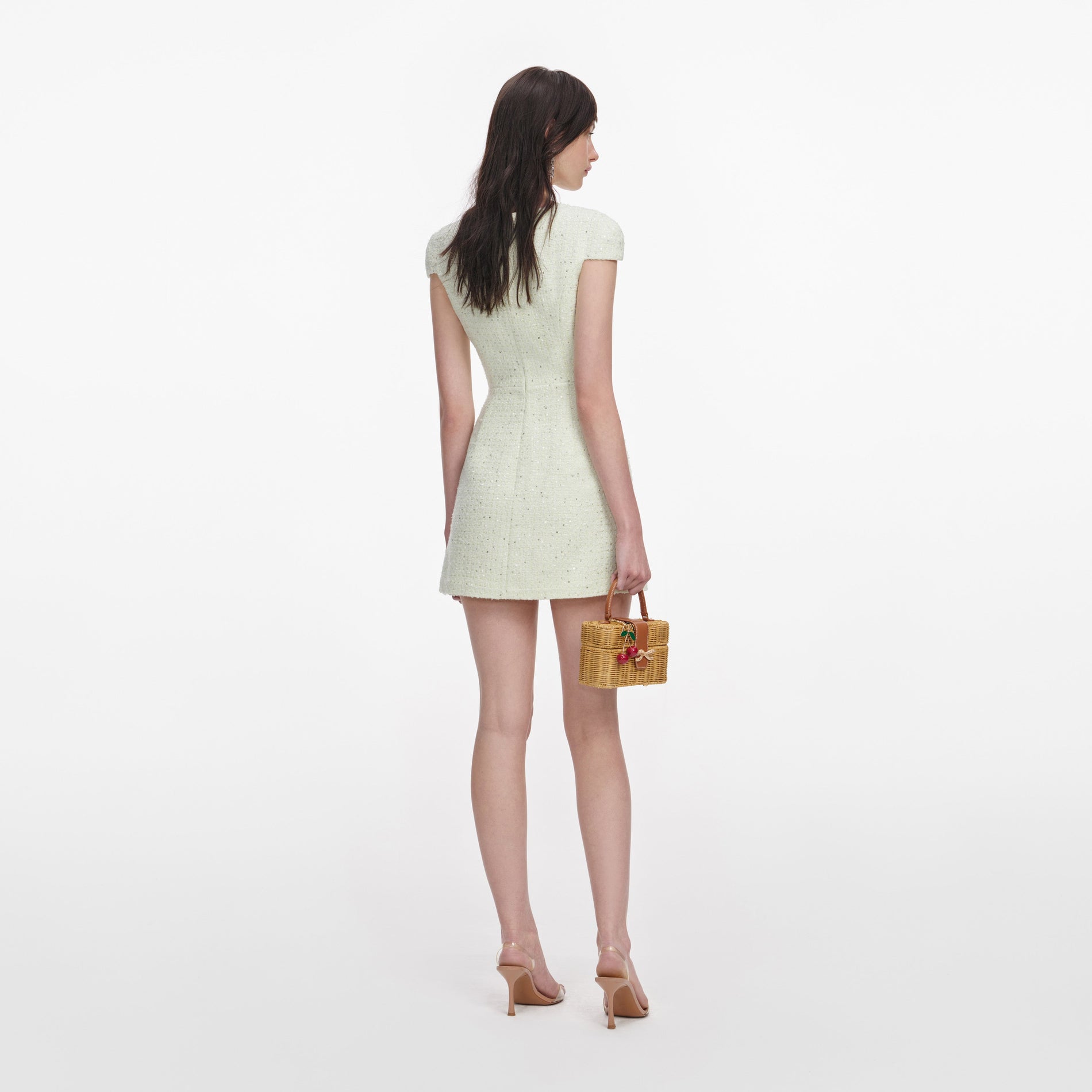Back view of a woman wearing the Lime Boucle Mini Dress