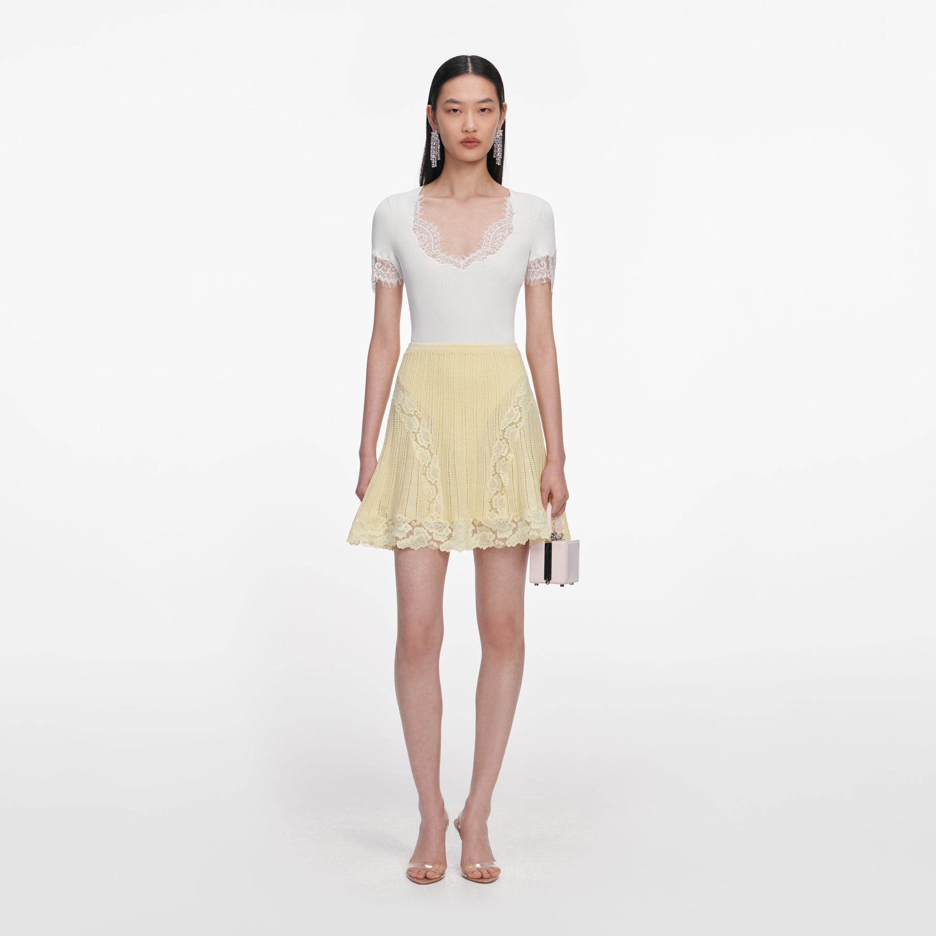 Front view of a woman wearing the Yellow Pointelle Knit Mini Skirt