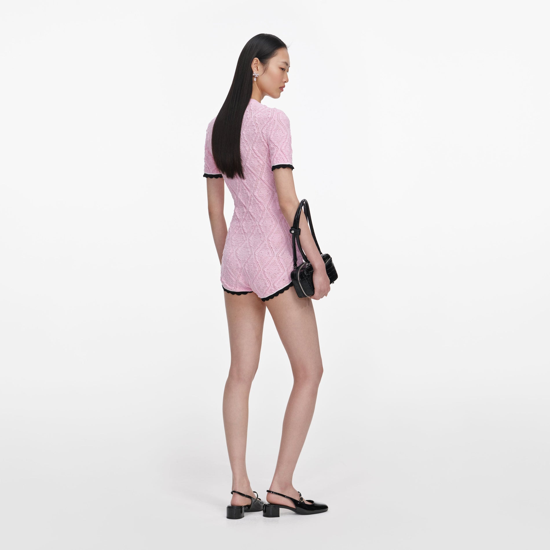 Back view of a woman wearing the Pink Pointelle Knit Playsuit
