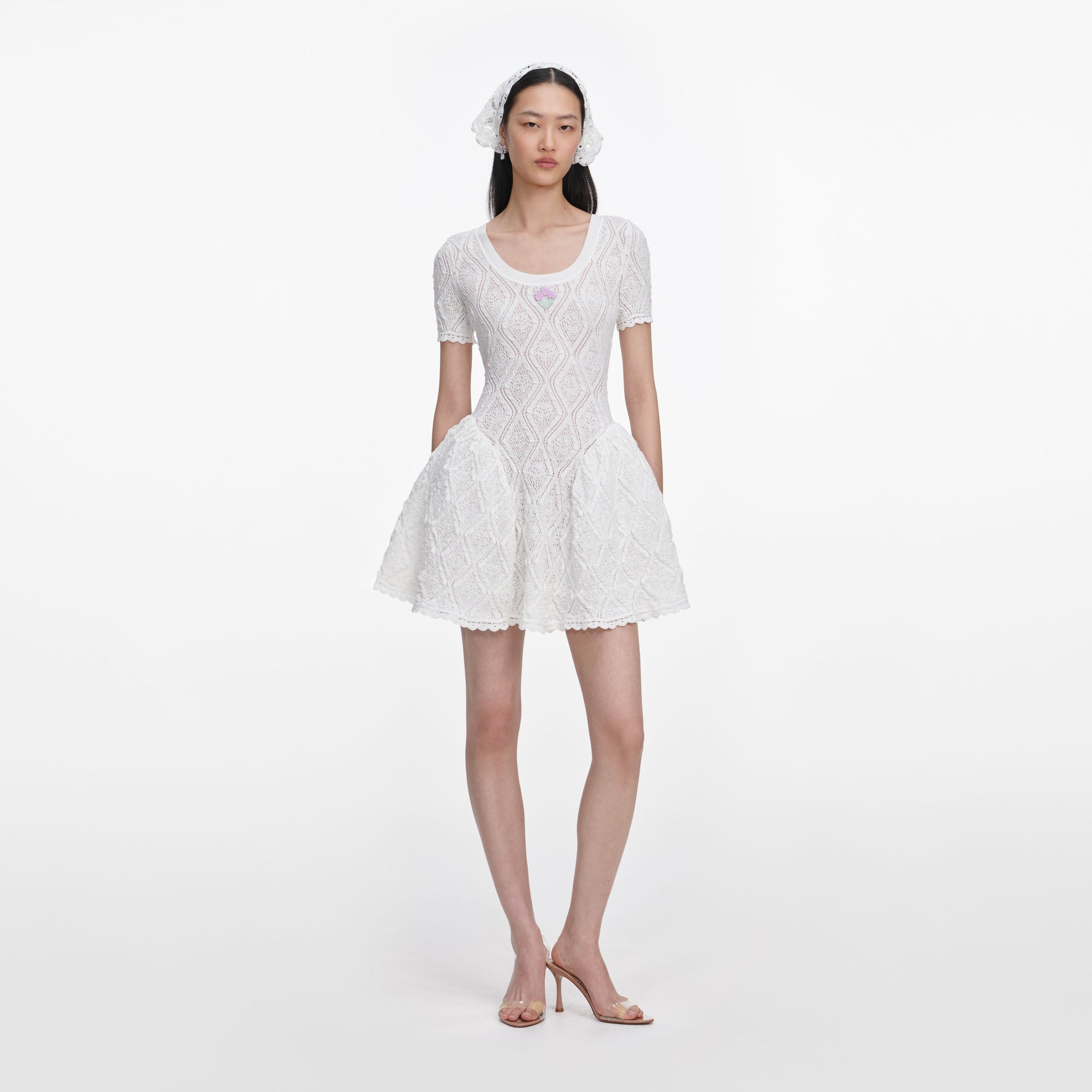 Front view of a woman wearing the White Pointelle Knit Flared Mini Dress