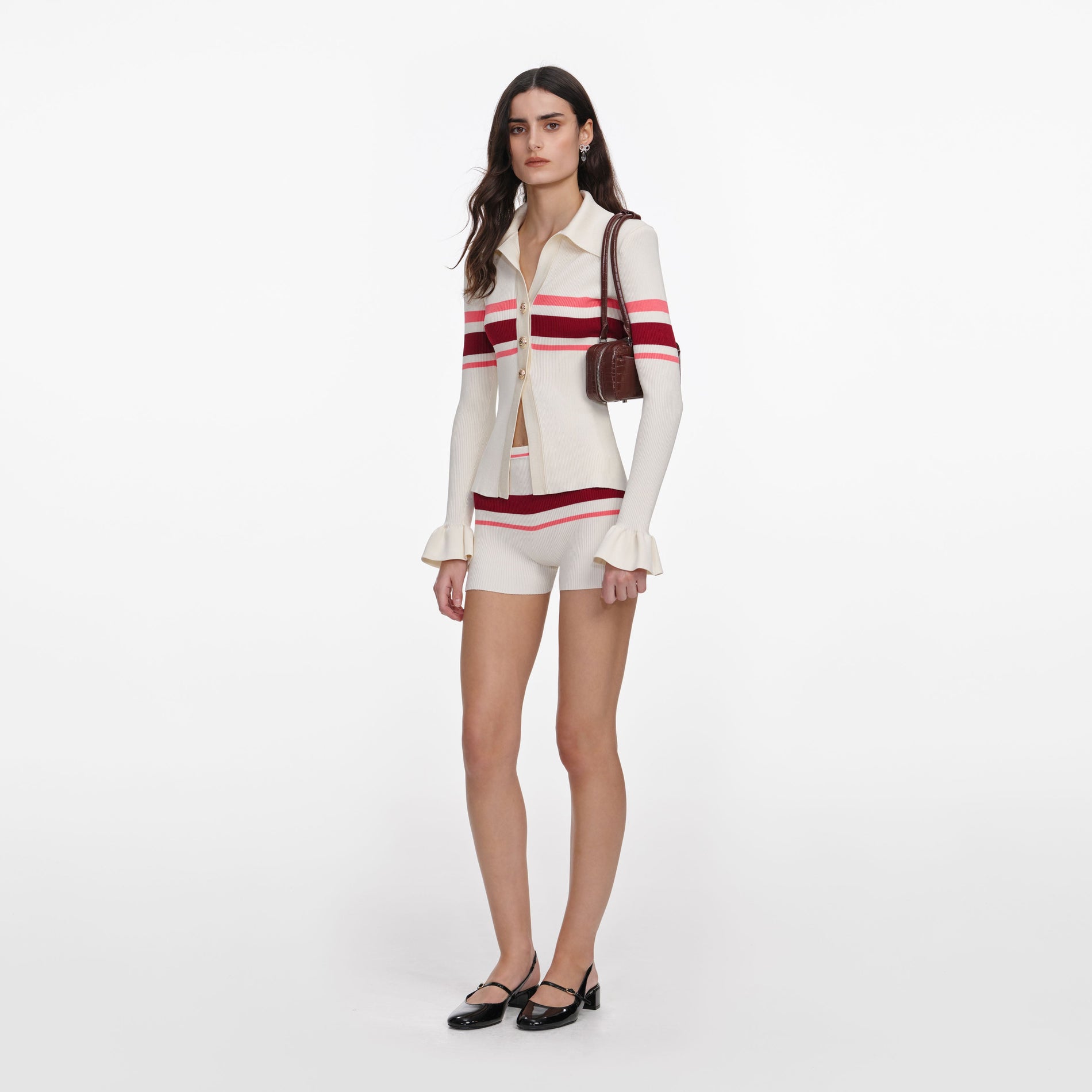 Side view of a woman wearing the Cream Stripe Viscose Knit Button Top