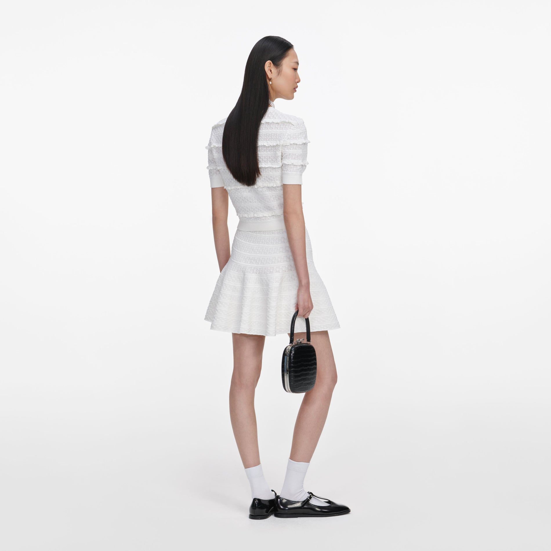 Back view of a woman wearing the White Pointelle Knit Top