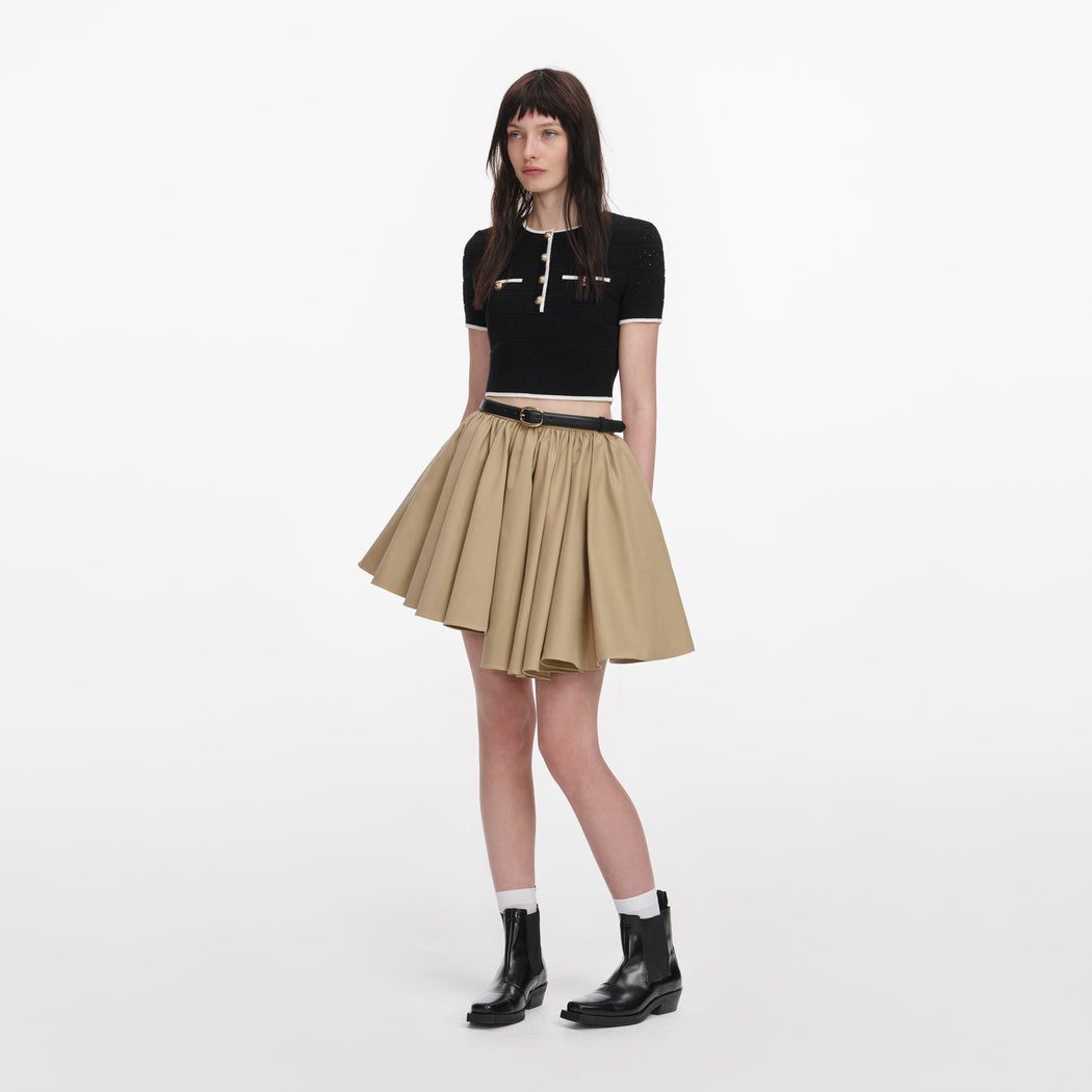 Side view of a woman wearing the Tan Cotton Mini Skirt