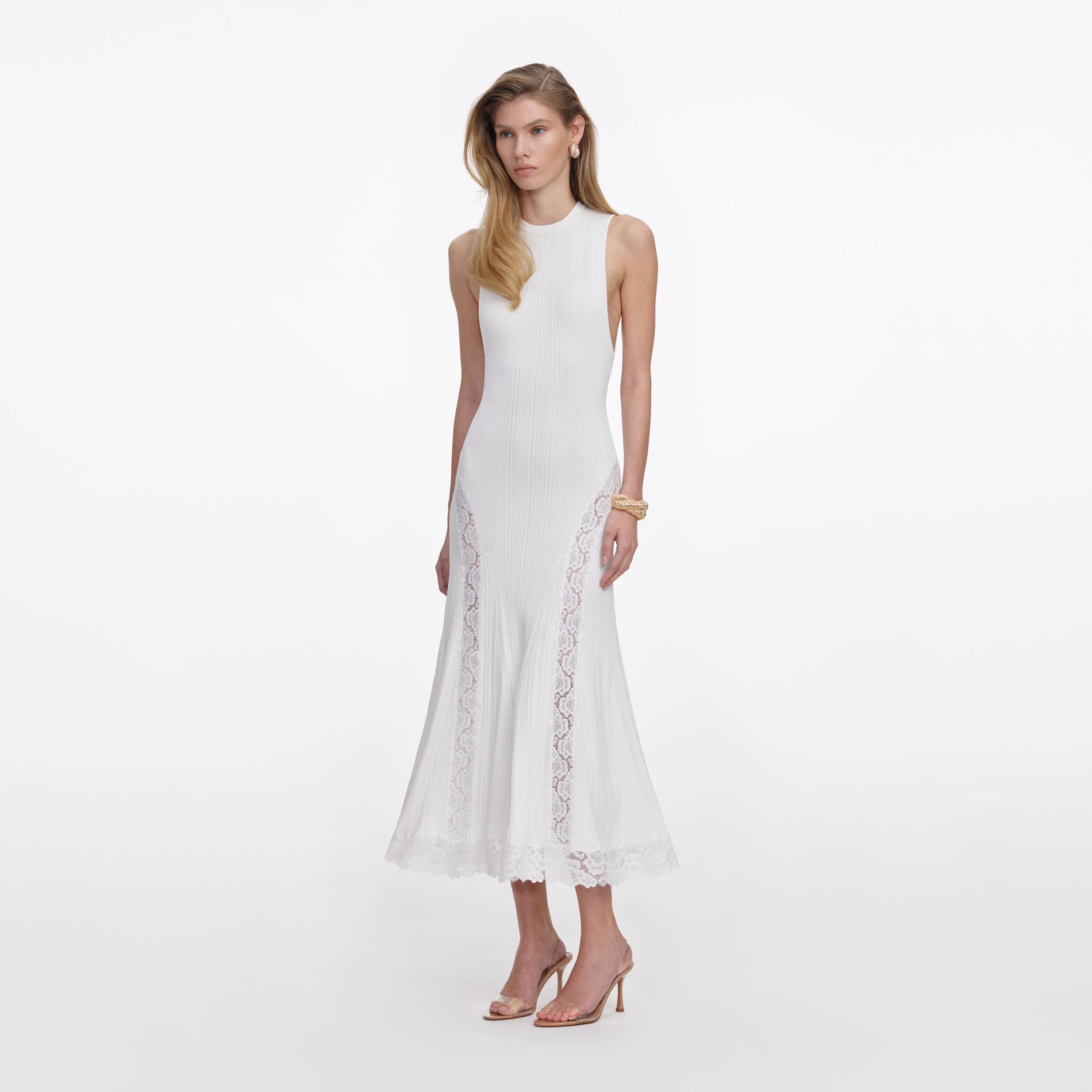 Side view of a woman wearing the White Knit Lace Insert Midi Dress