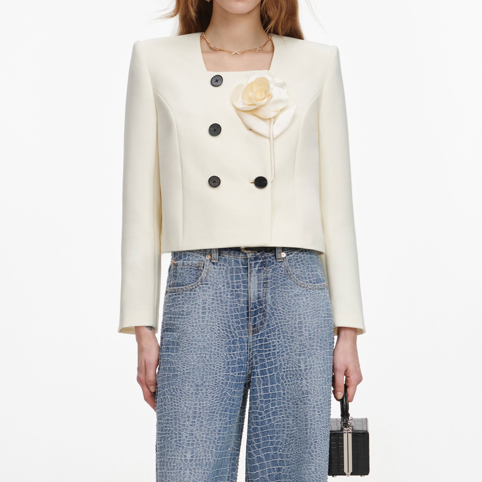 A close up of a woman wearing the Cream 3D Flower Jacket