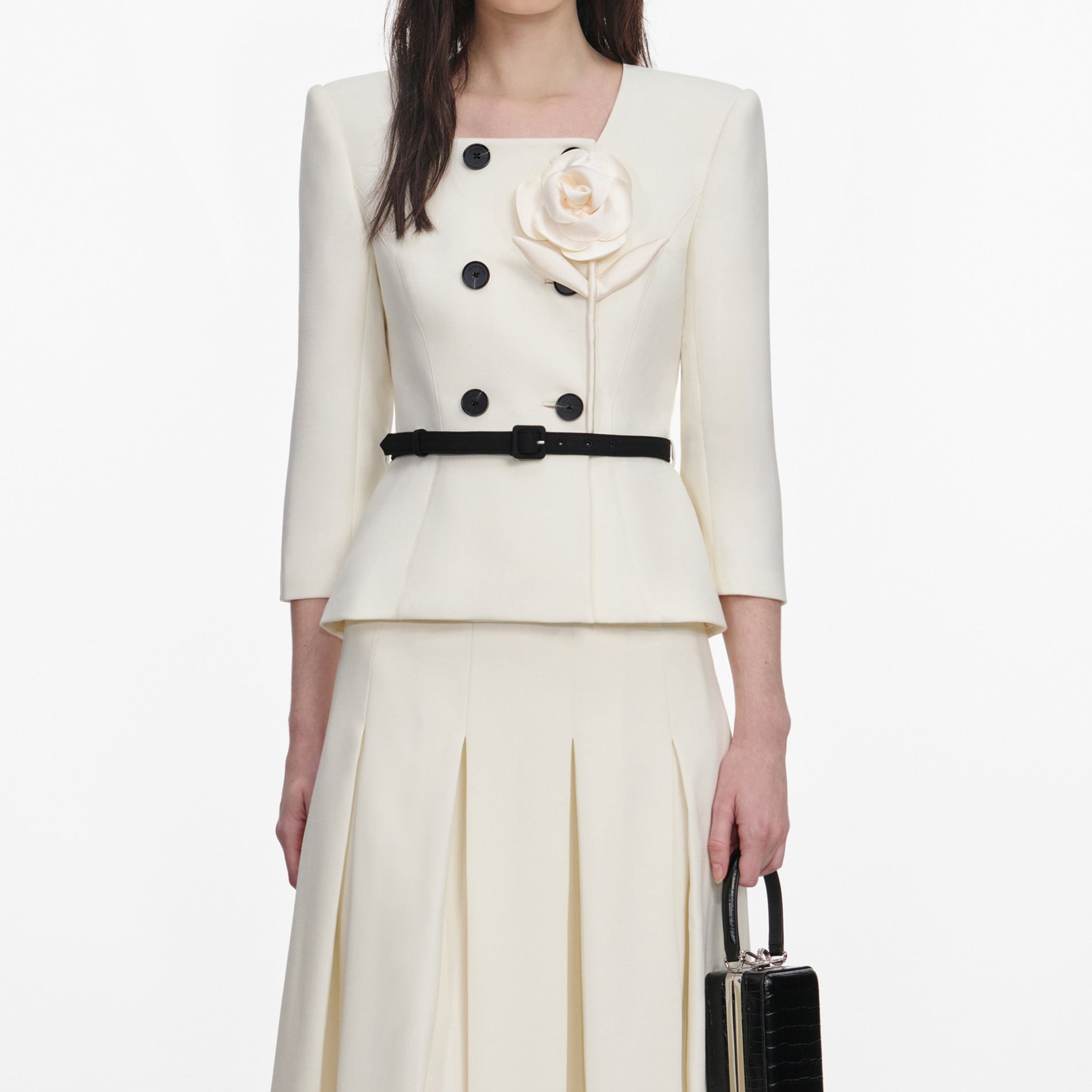 A close up of a woman wearing the Cream 3D Flower Tailored Midi Dress