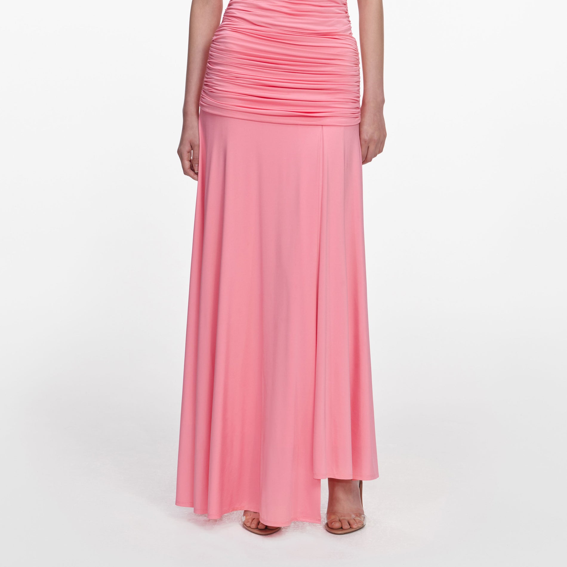 A close up of a woman wearing the Pink Jersey Gathered Maxi Skirt