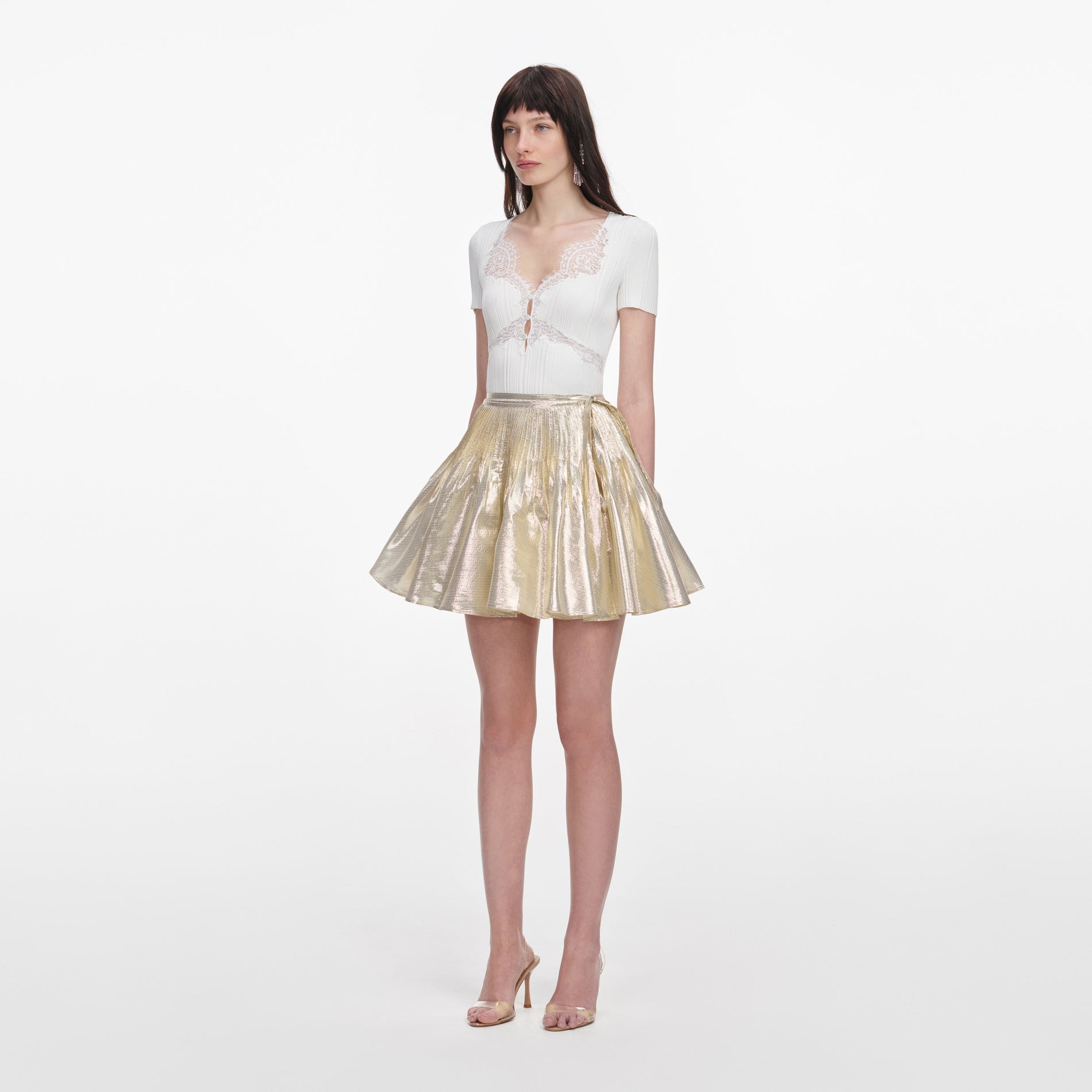 Side view of a woman wearing the White Lace Trim Knit Top