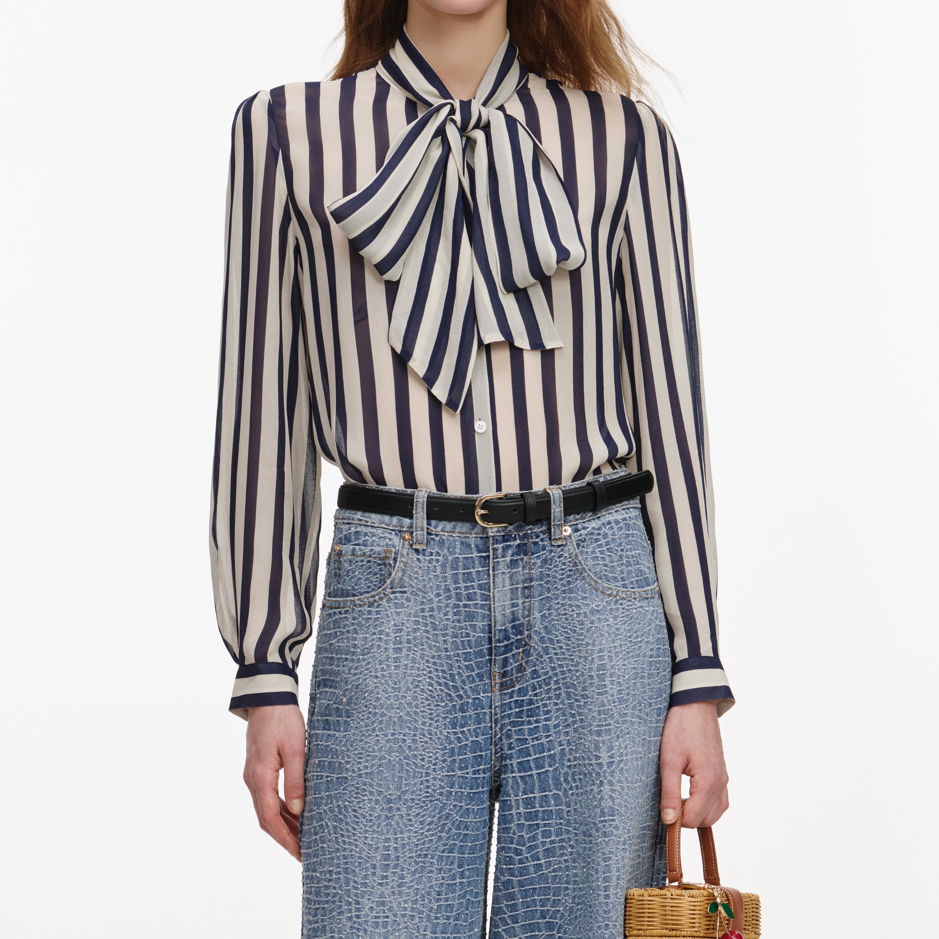 A close up of a woman wearing the Navy Stripe Tie Neck Blouse