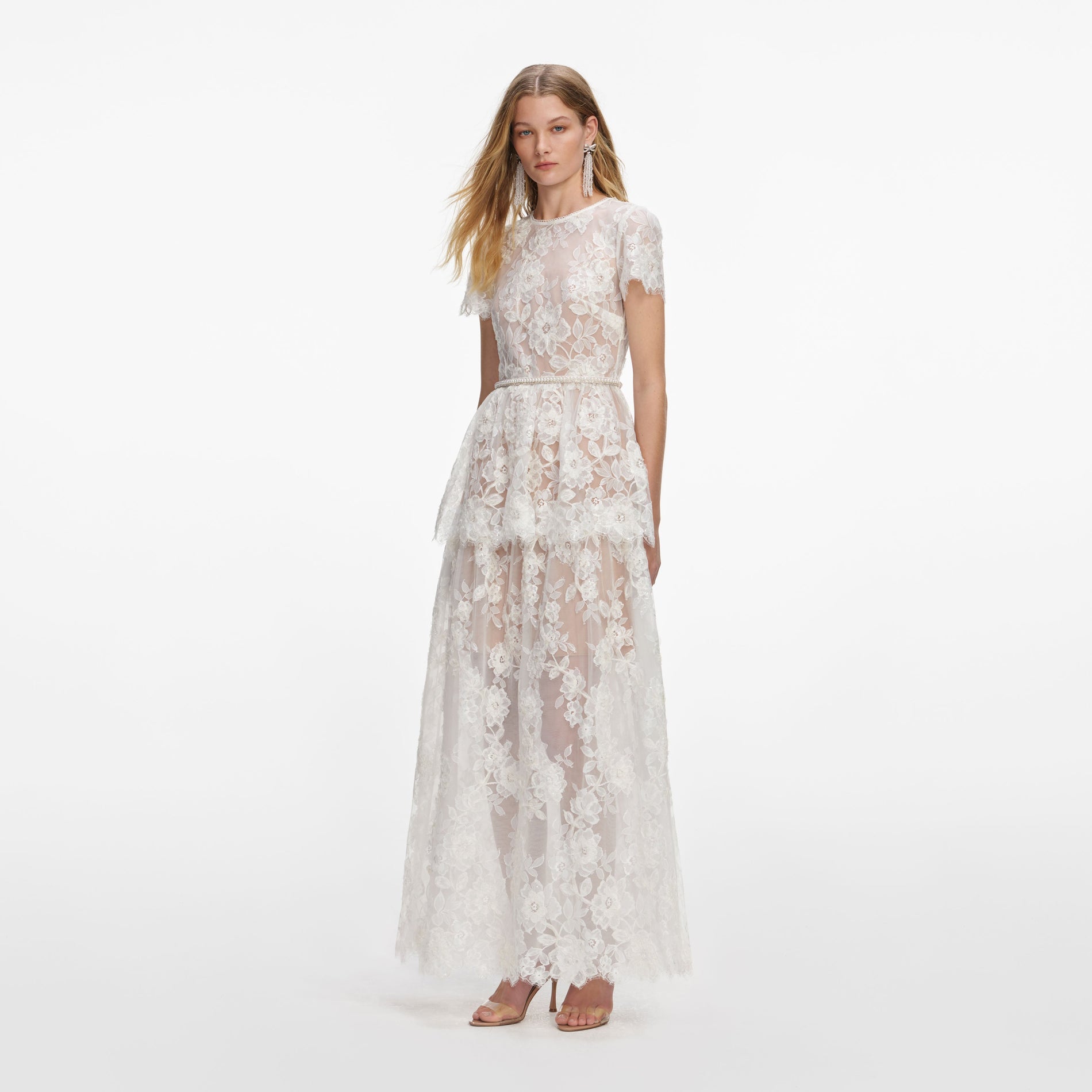 Side view of a woman wearing the White Sequin Lace Tiered Maxi Dress