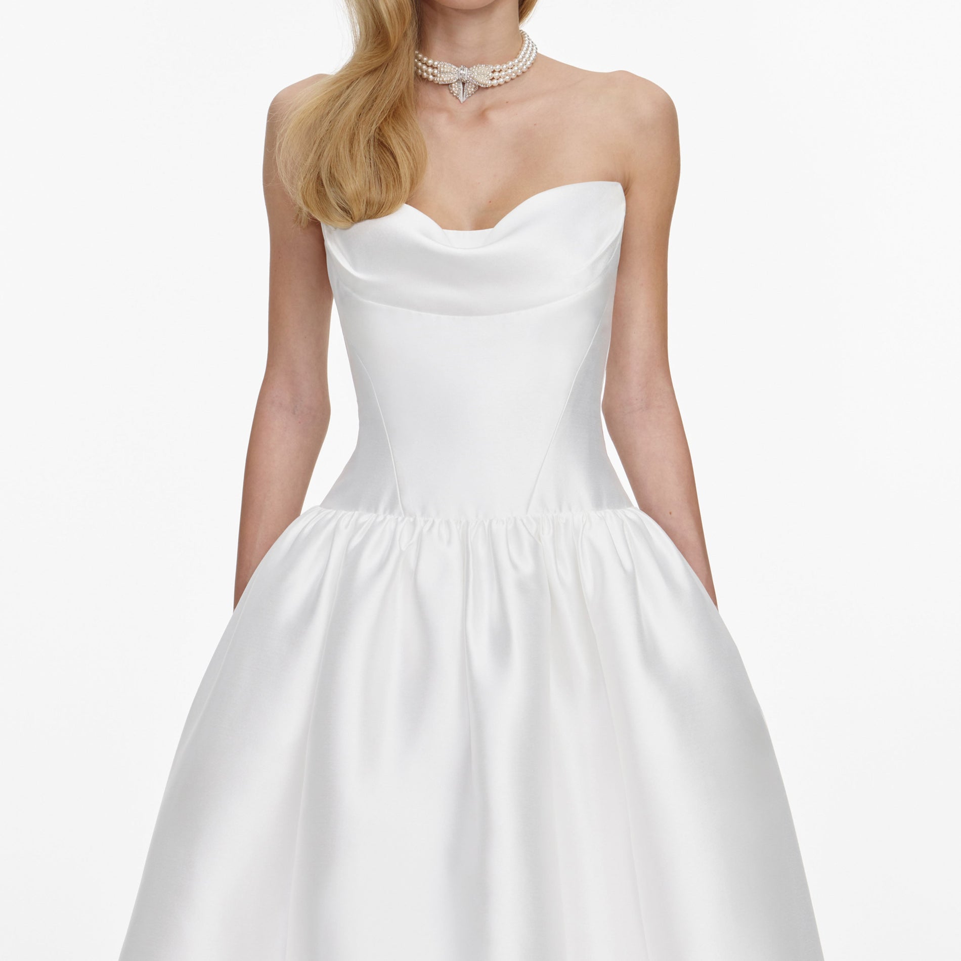 A close up of a woman wearing the White Taffeta Strapless Midi Dress
