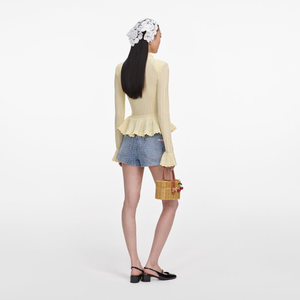 Back view of a woman wearing the Rhinestone Croc Effect Denim Shorts
