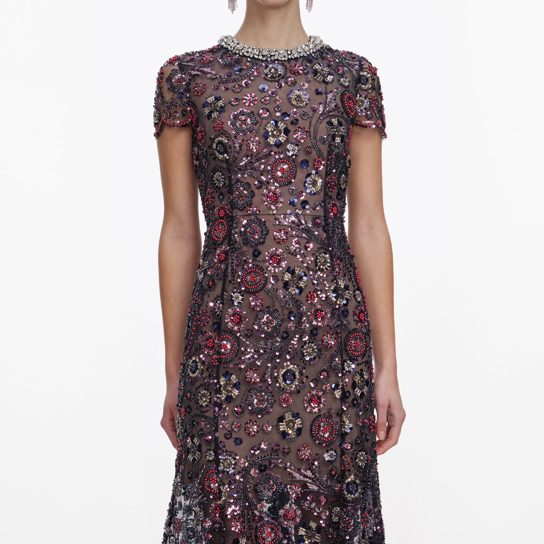 A close up of a woman wearing the Navy Floral Sequin Midi Dress