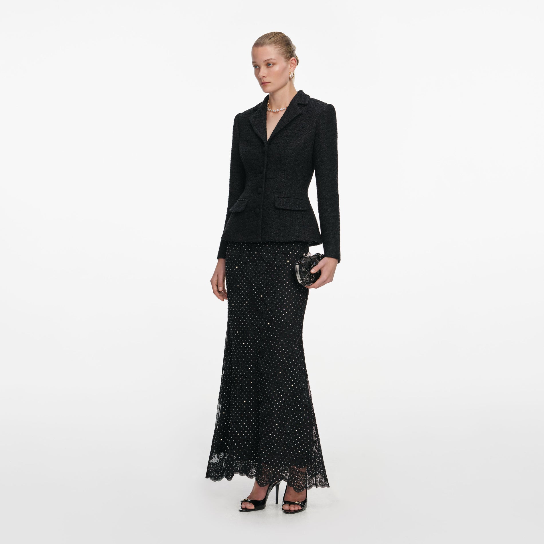Side view of a woman wearing the Black Boucle Rhinestone Lace Maxi Dress