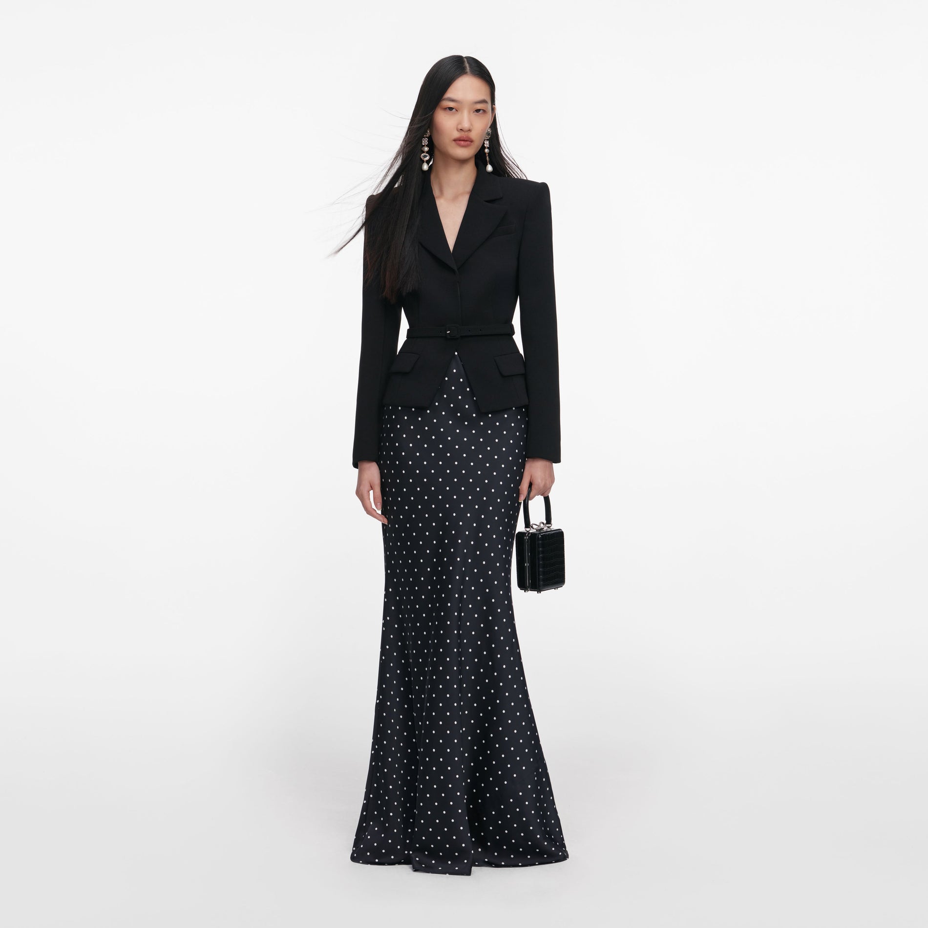Front view of a woman wearing the Black Crepe Polka Dot Maxi Dress